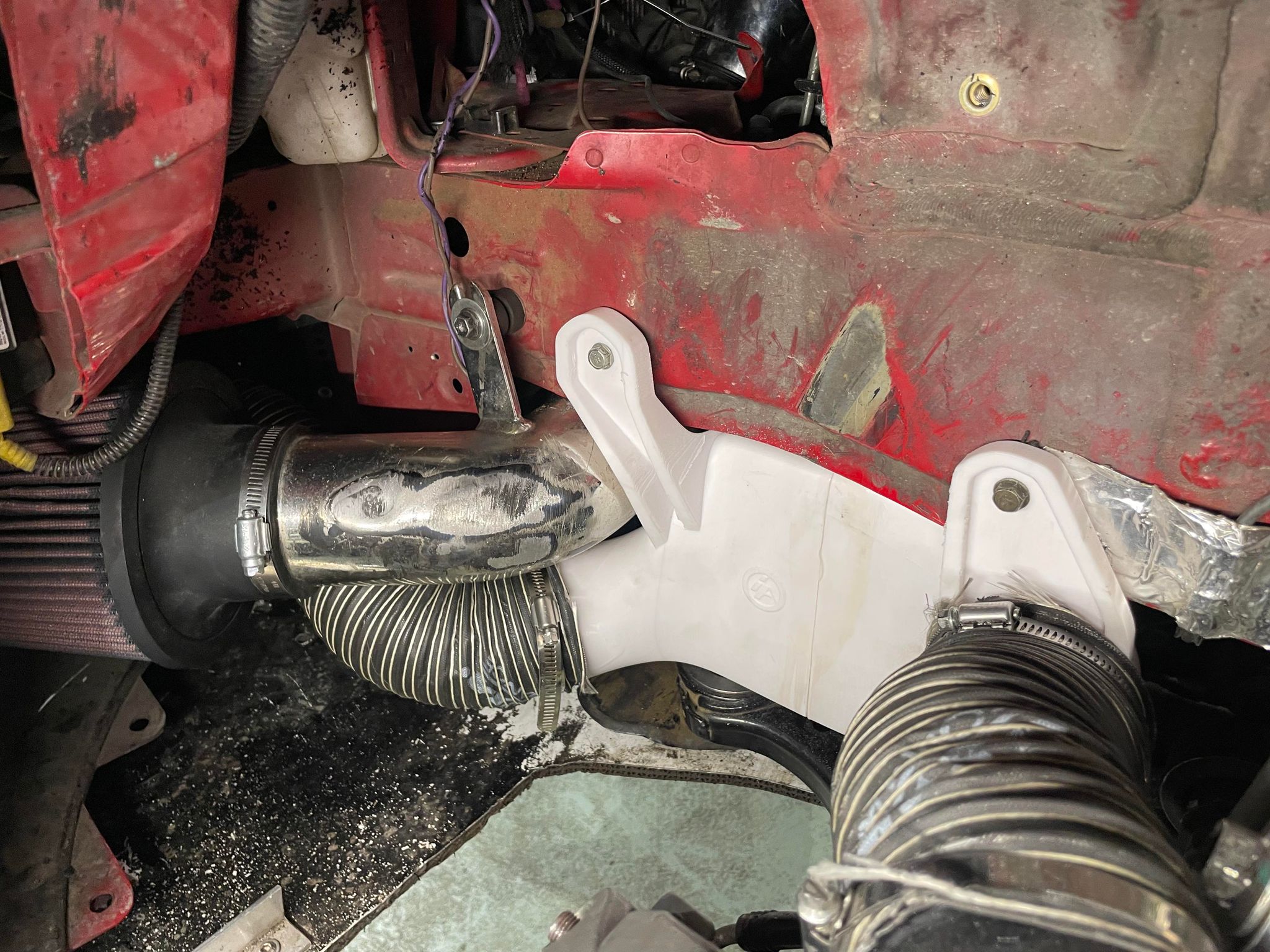 Brake duct hose routed behind the front bumper on a red Civic Coupe race car