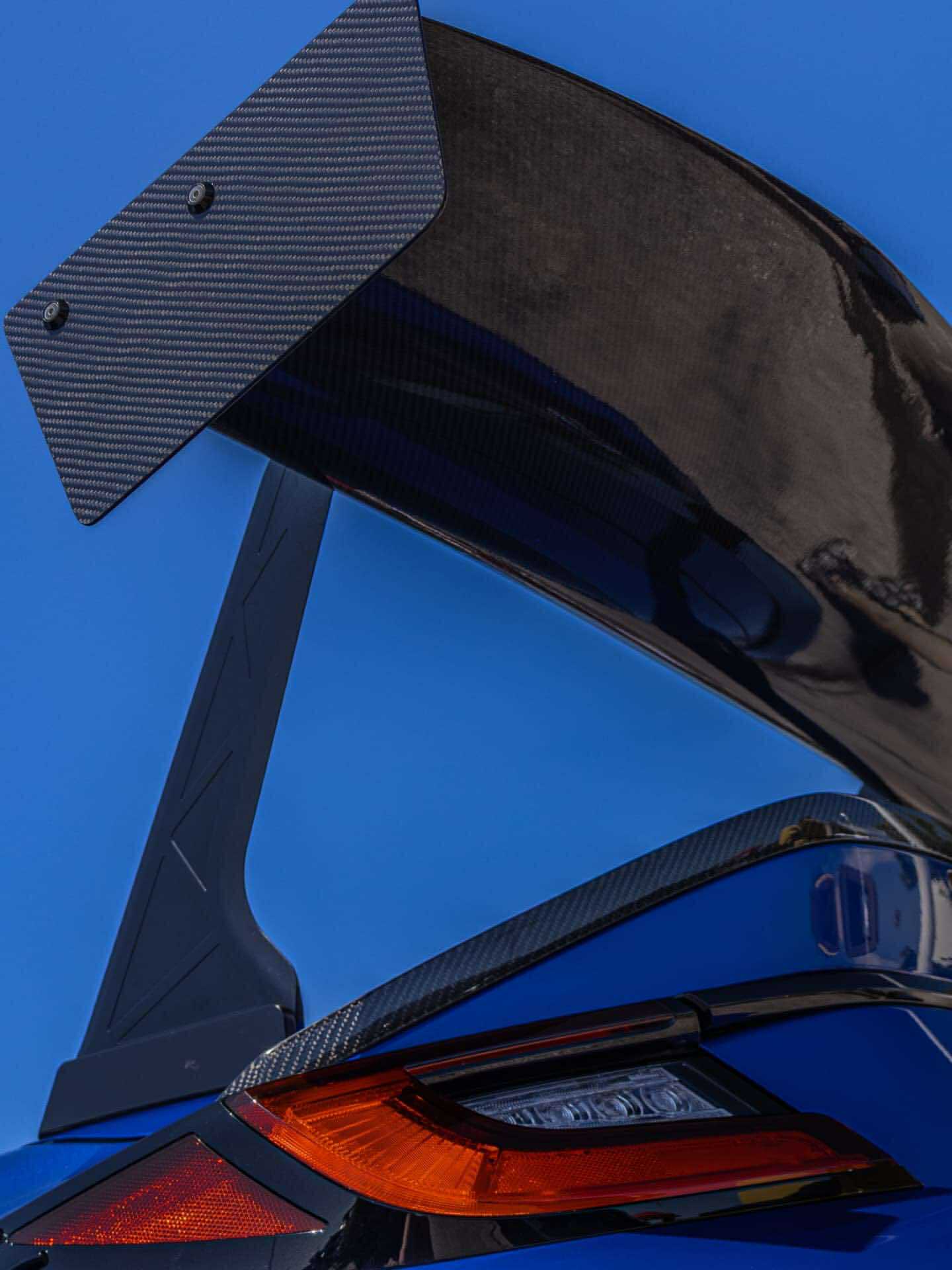 Close-up of the carbon fiber GT wing endplate on a blue BRZ ZN8