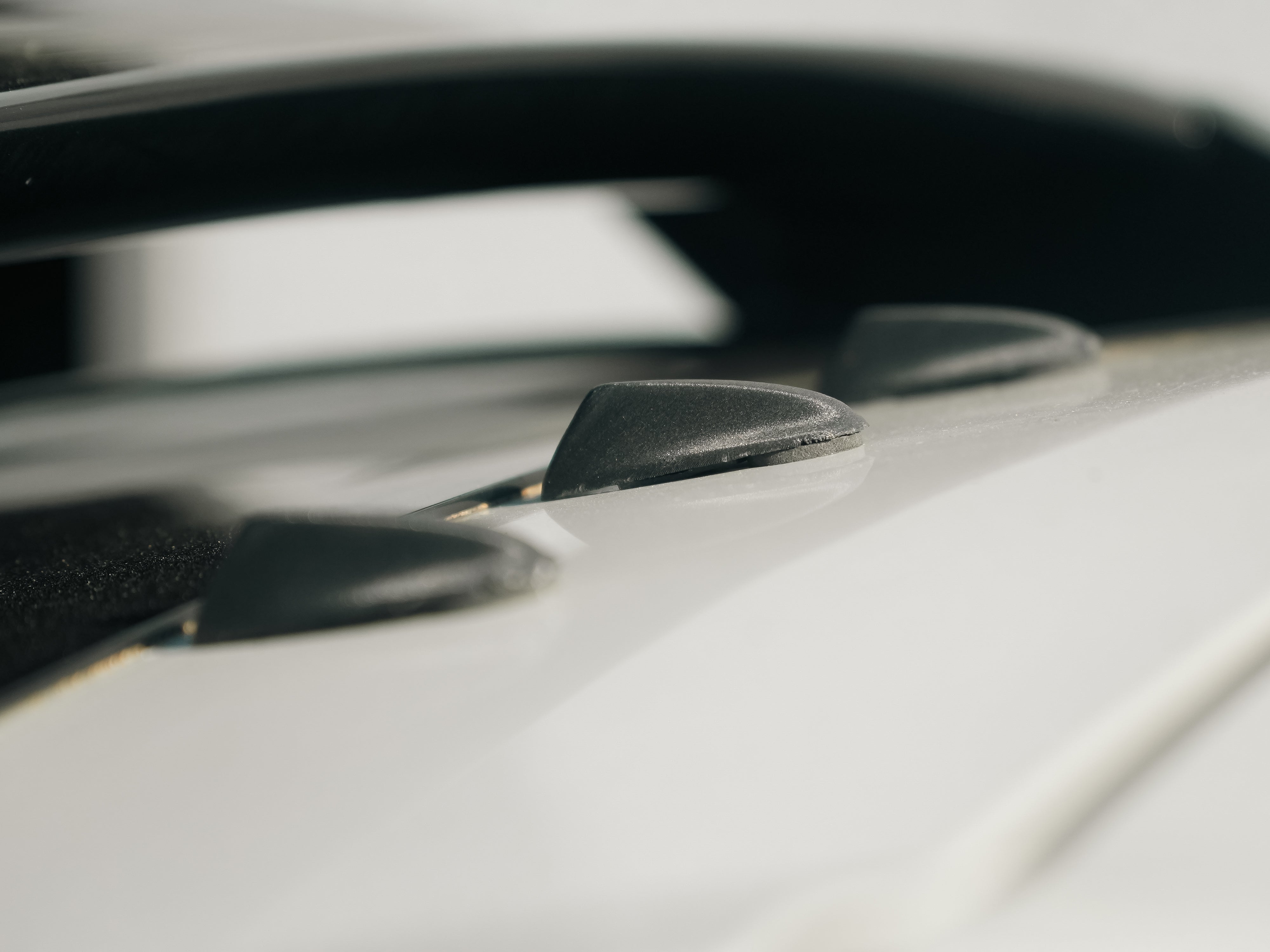 Close-up of vortex generator plugs installed on a white GR Corolla wing