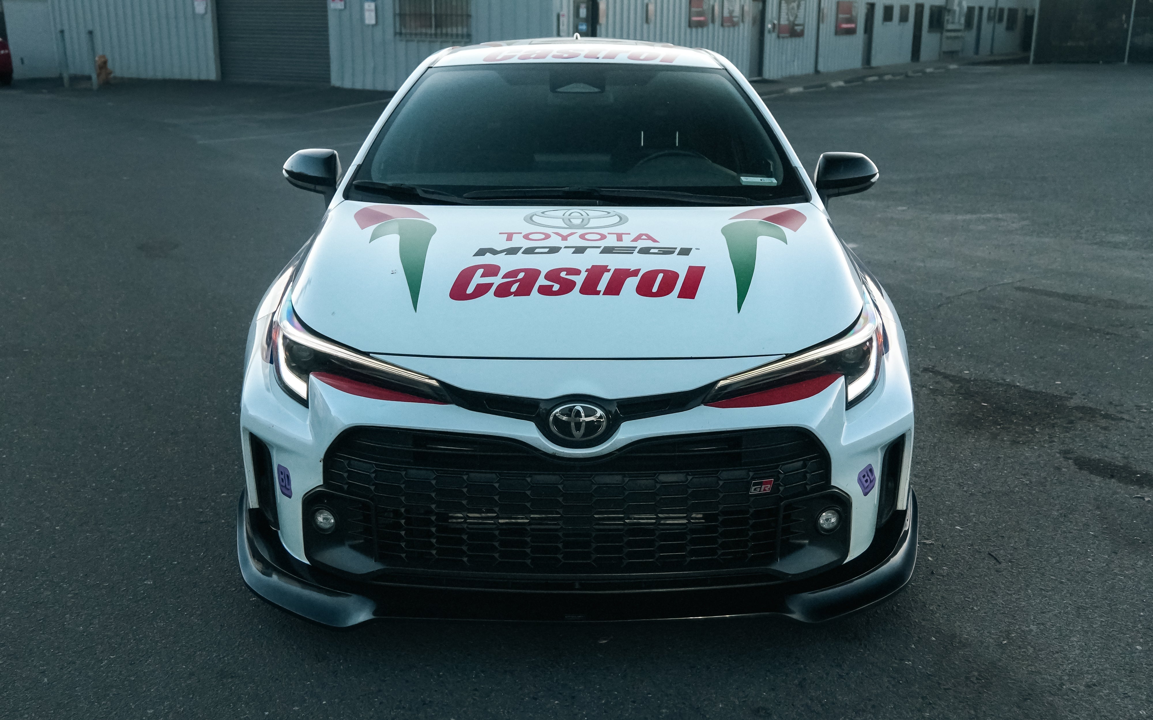 Front-on view of a white Castrol-livery GR Corolla rally car with front lip V2