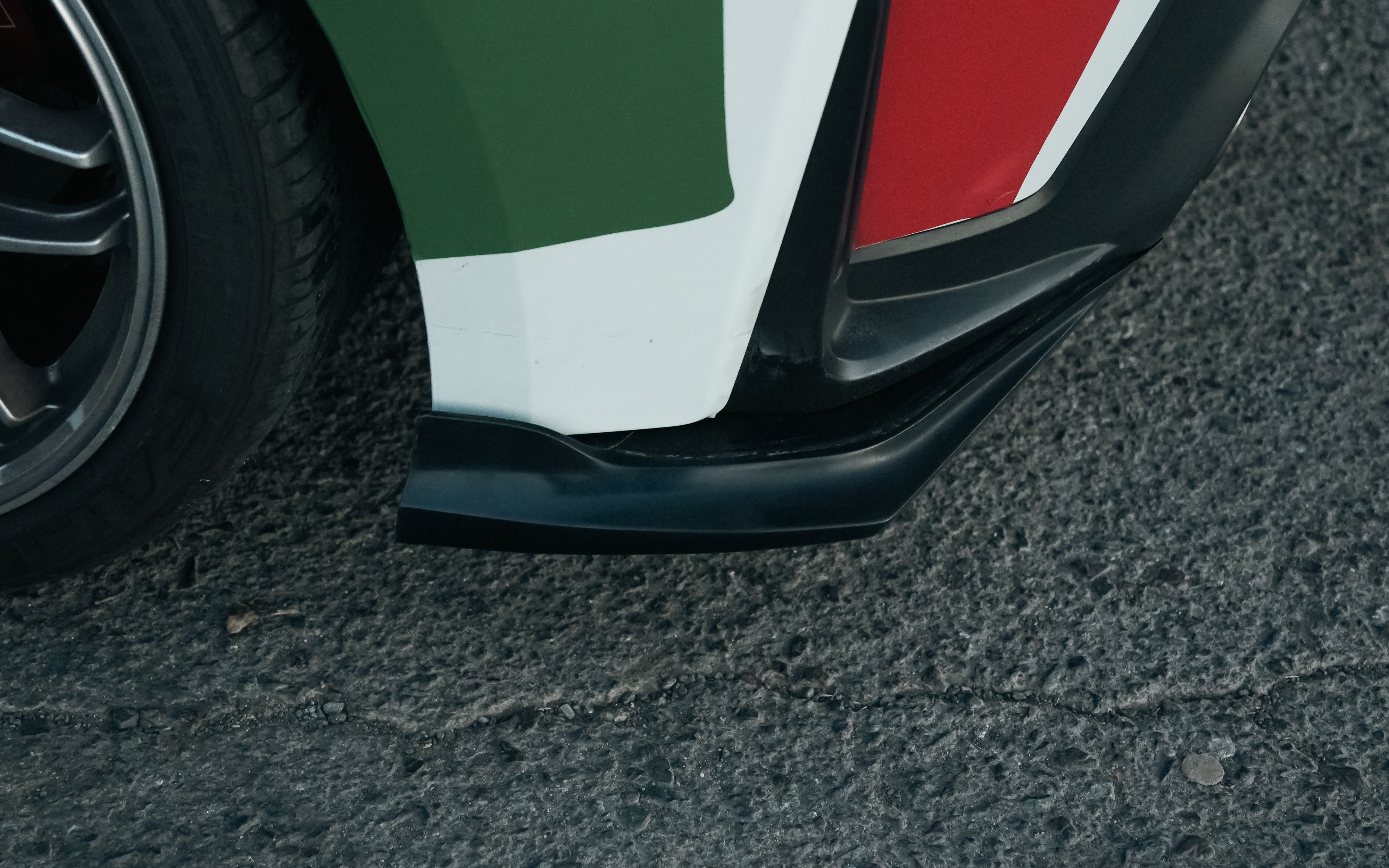 Close-up of the rear spat V2 on a white Castrol-livery GR Corolla rally car