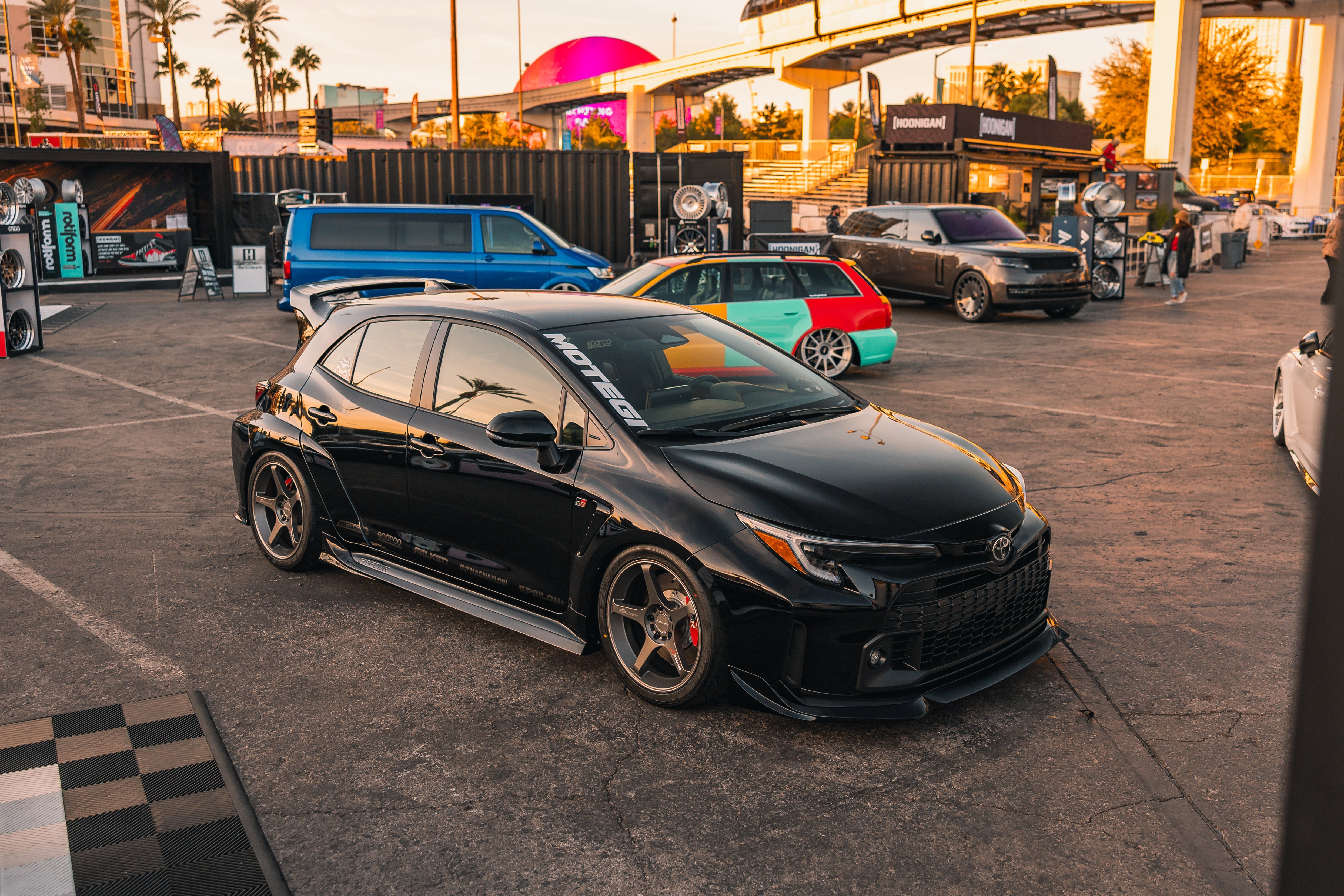 Front three-quarter view of a black GR Corolla with front lip parked outdoors