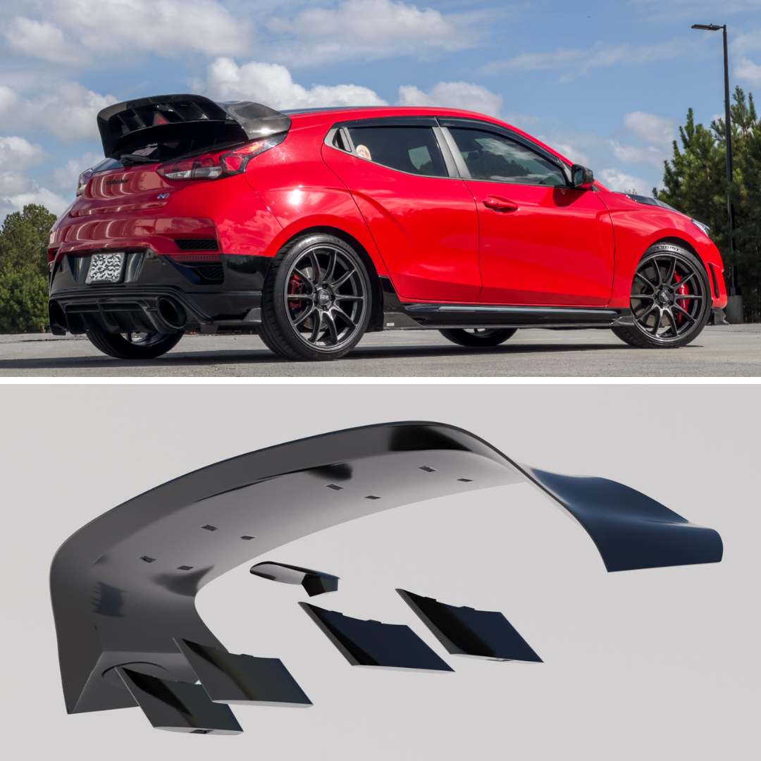 Rear three-quarter view of a red Hyundai Veloster N with WRC Wing V2 in a parking garage