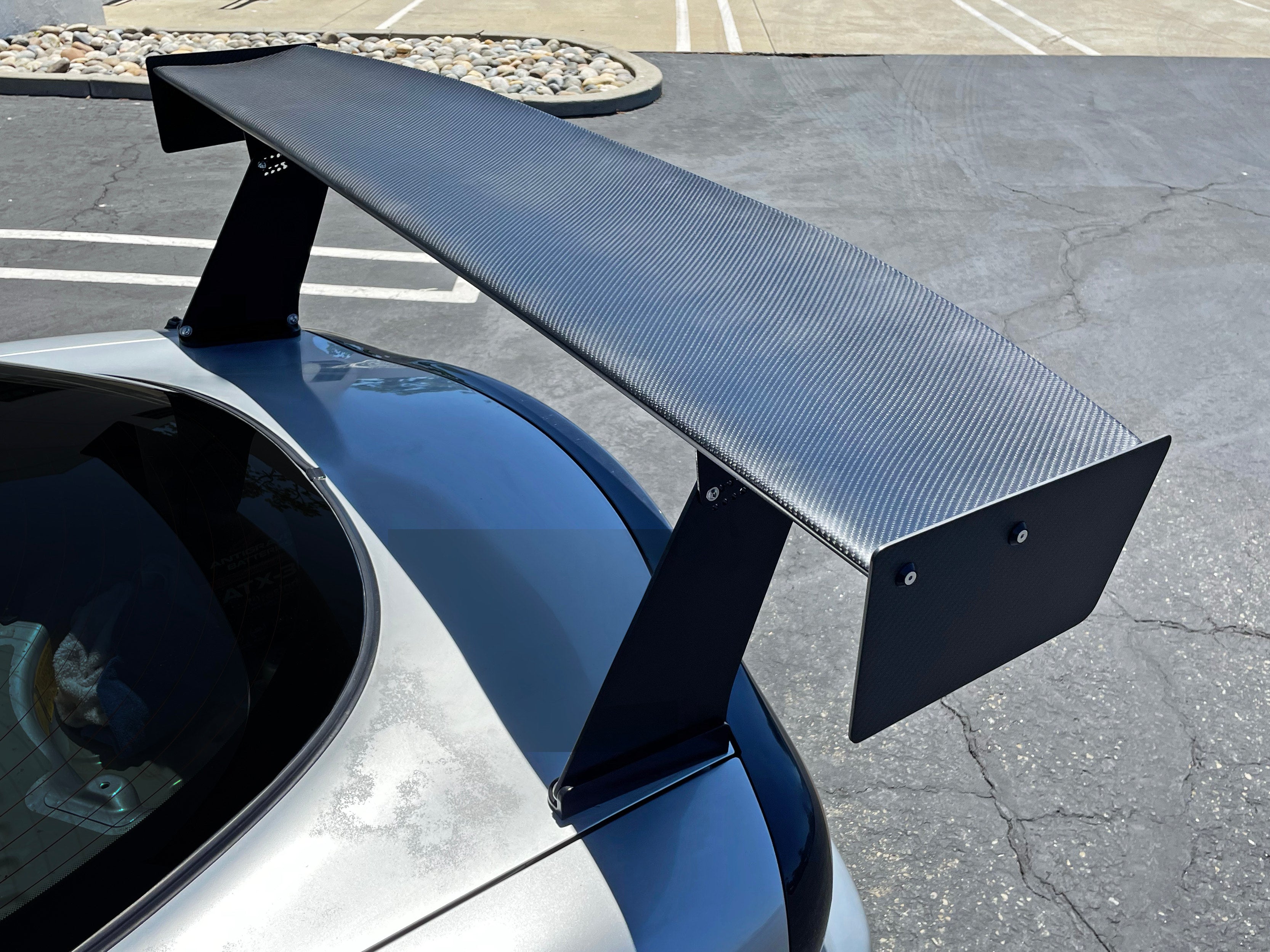 Close-up rear view of the carbon fiber GT wing and swan neck mount