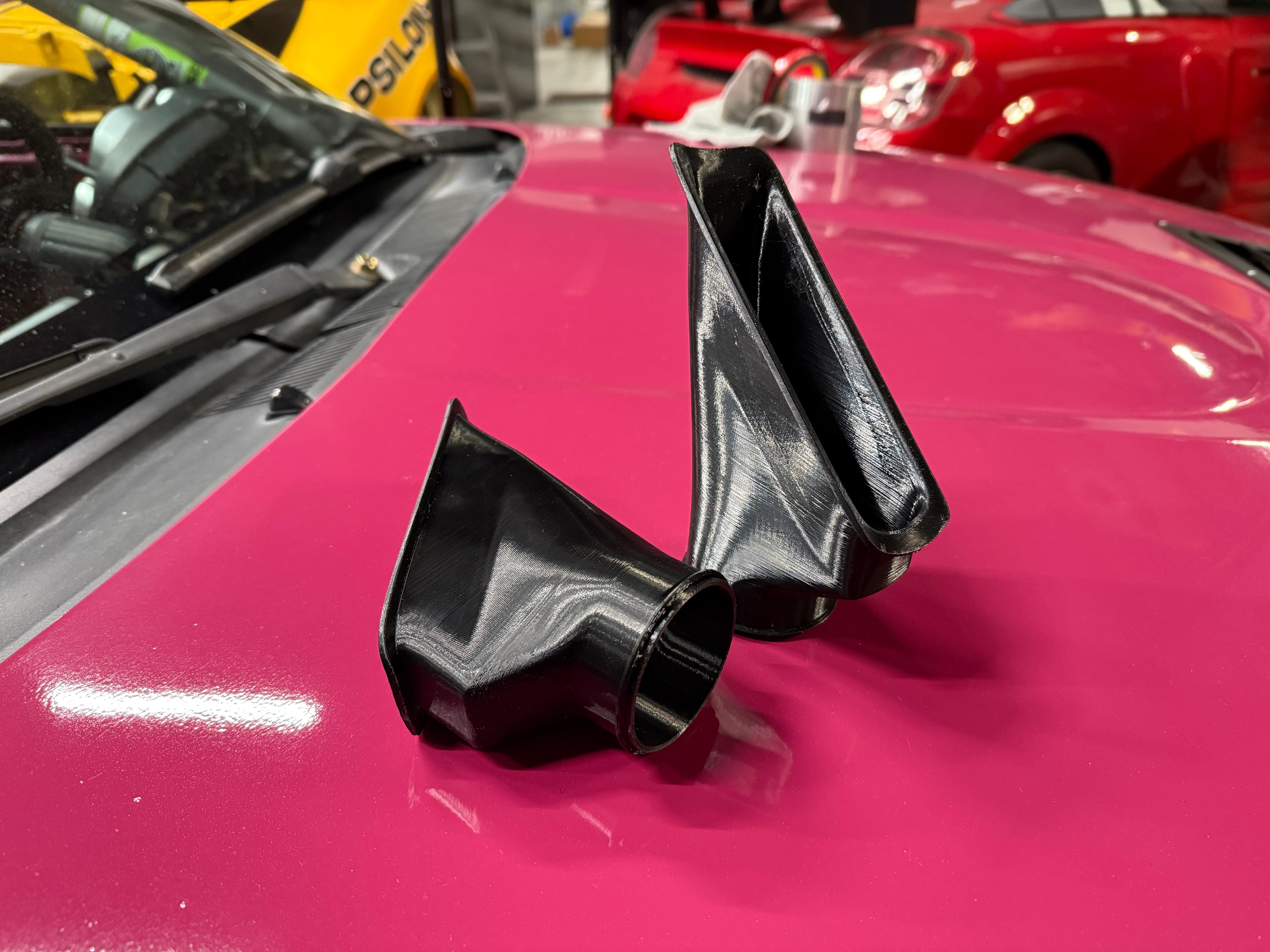 Close-up of the brake duct inlets installed on a pink Miata NC front bumper