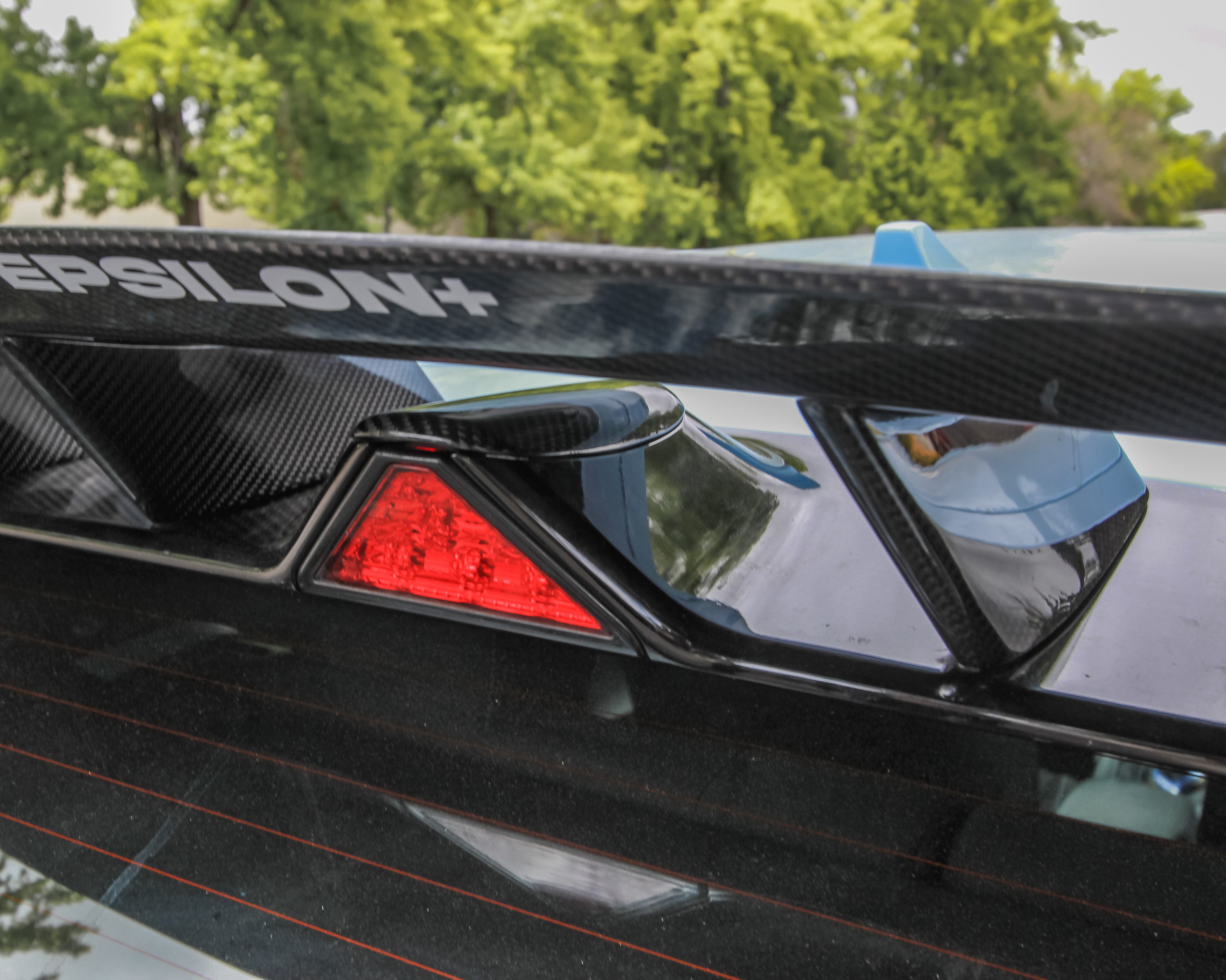 Close-up of the WRC Wing V2 carbon fiber weave and mounting hardware