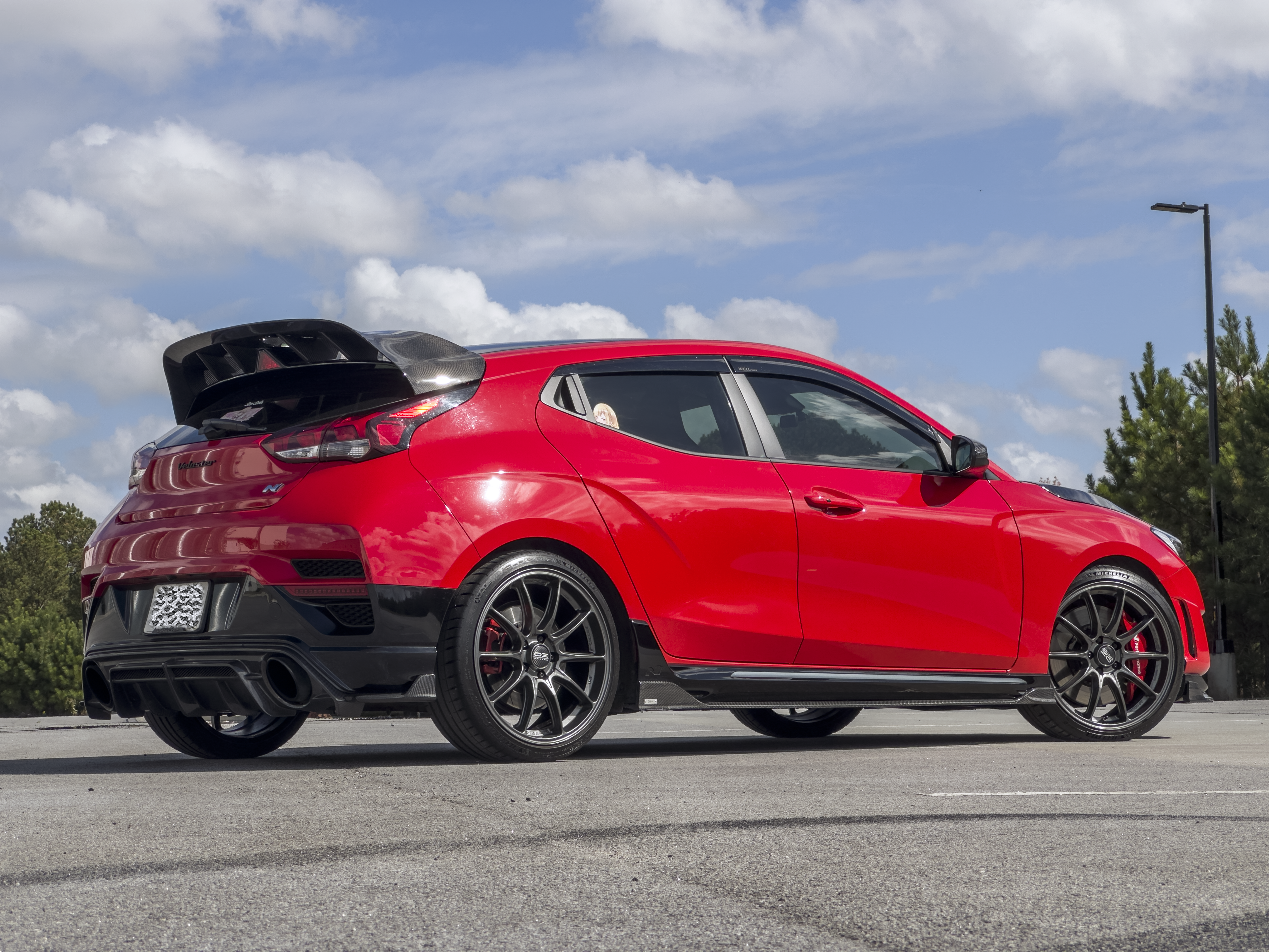 Close-up rear view of the WRC Wing V2 with third brake light cover on a red Veloster N