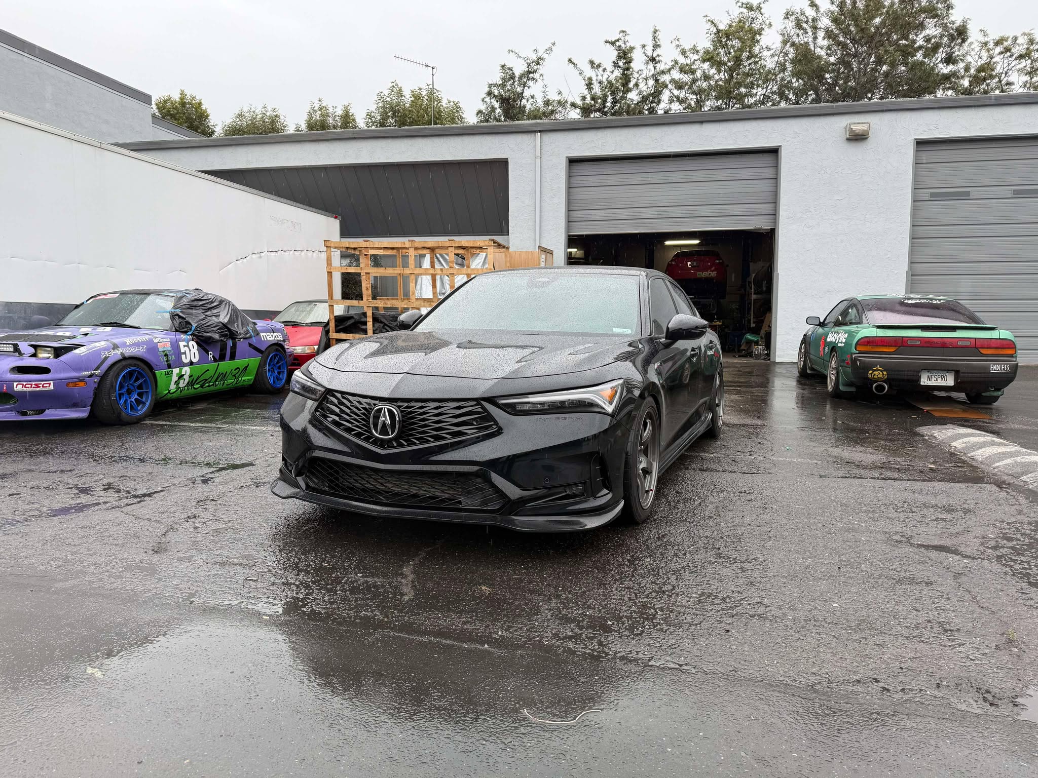 Front-on view of a black Acura Integra fitted with the Epsilon+ front lip
