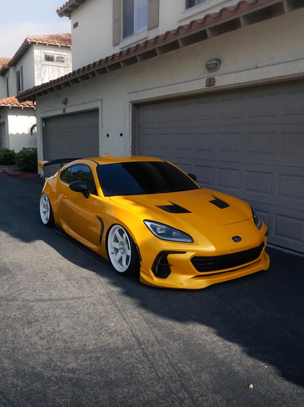 Front three-quarter view of a yellow Subaru BRZ ZN8 with front lip