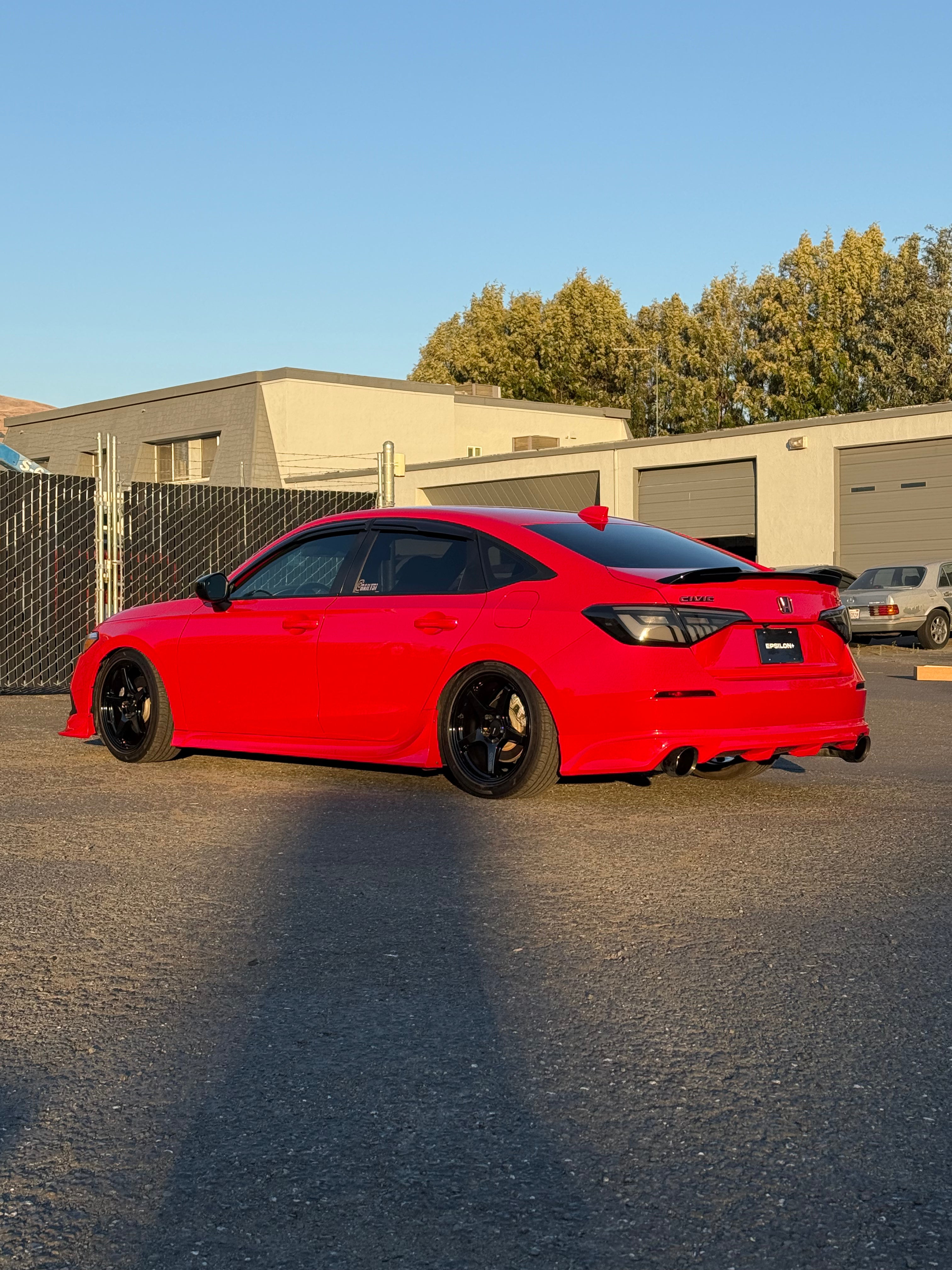 Side-front view of a red Honda Civic with the Epsilon+ side skirts