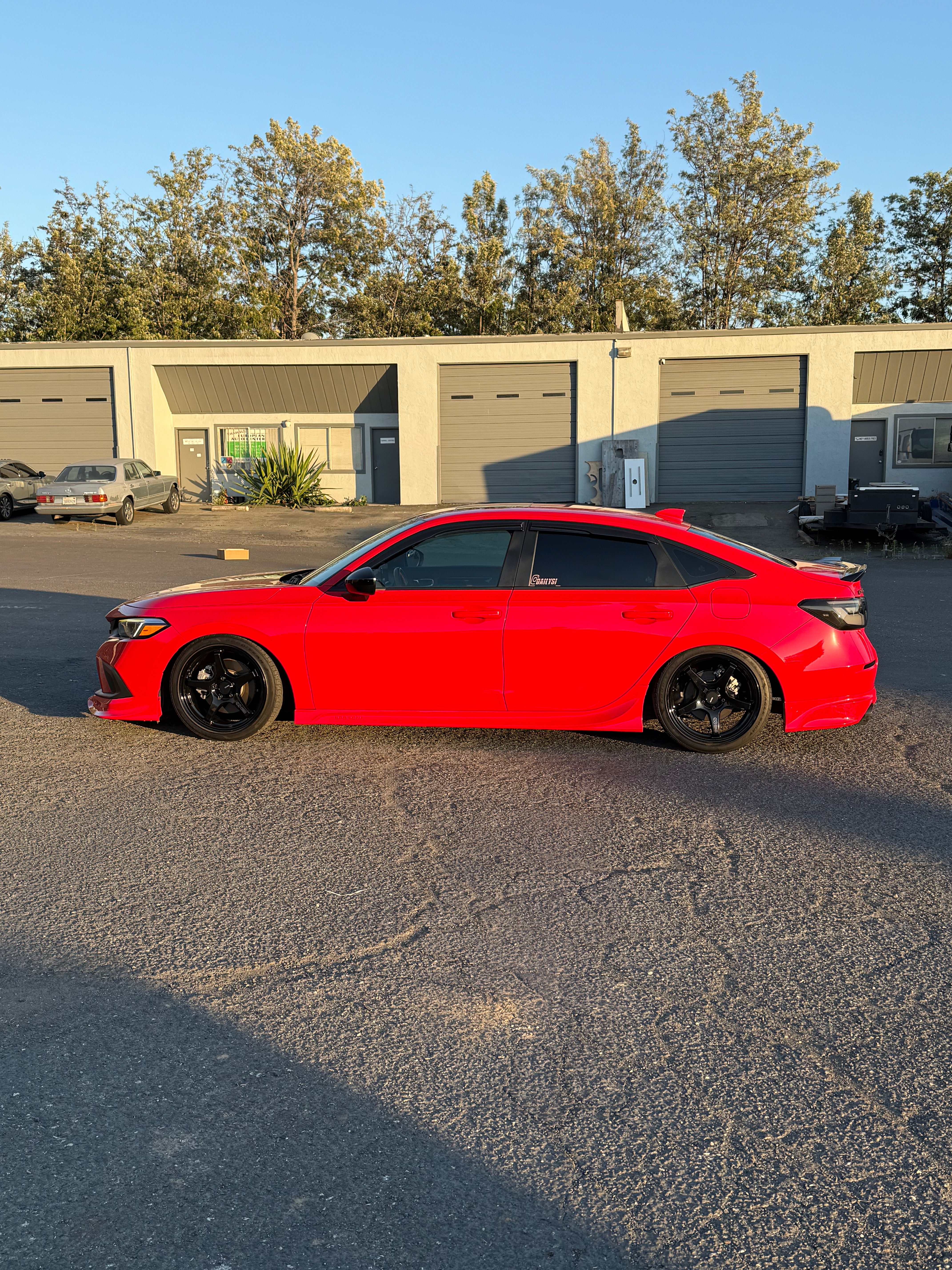 Side-rear view of a red Honda Civic with the Epsilon+ side skirts