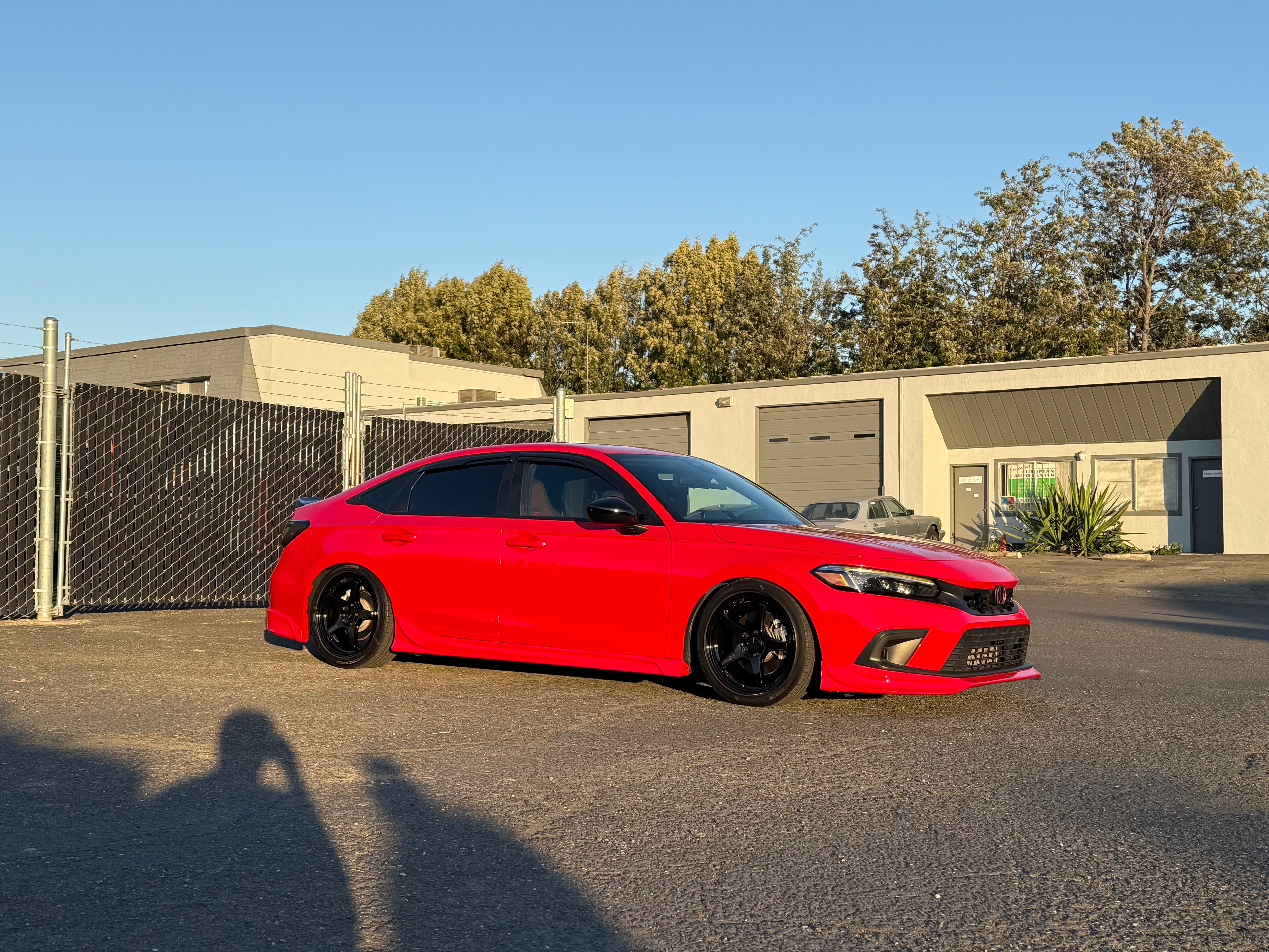 Side view of a red Honda Civic with the Epsilon+ side skirts fitted