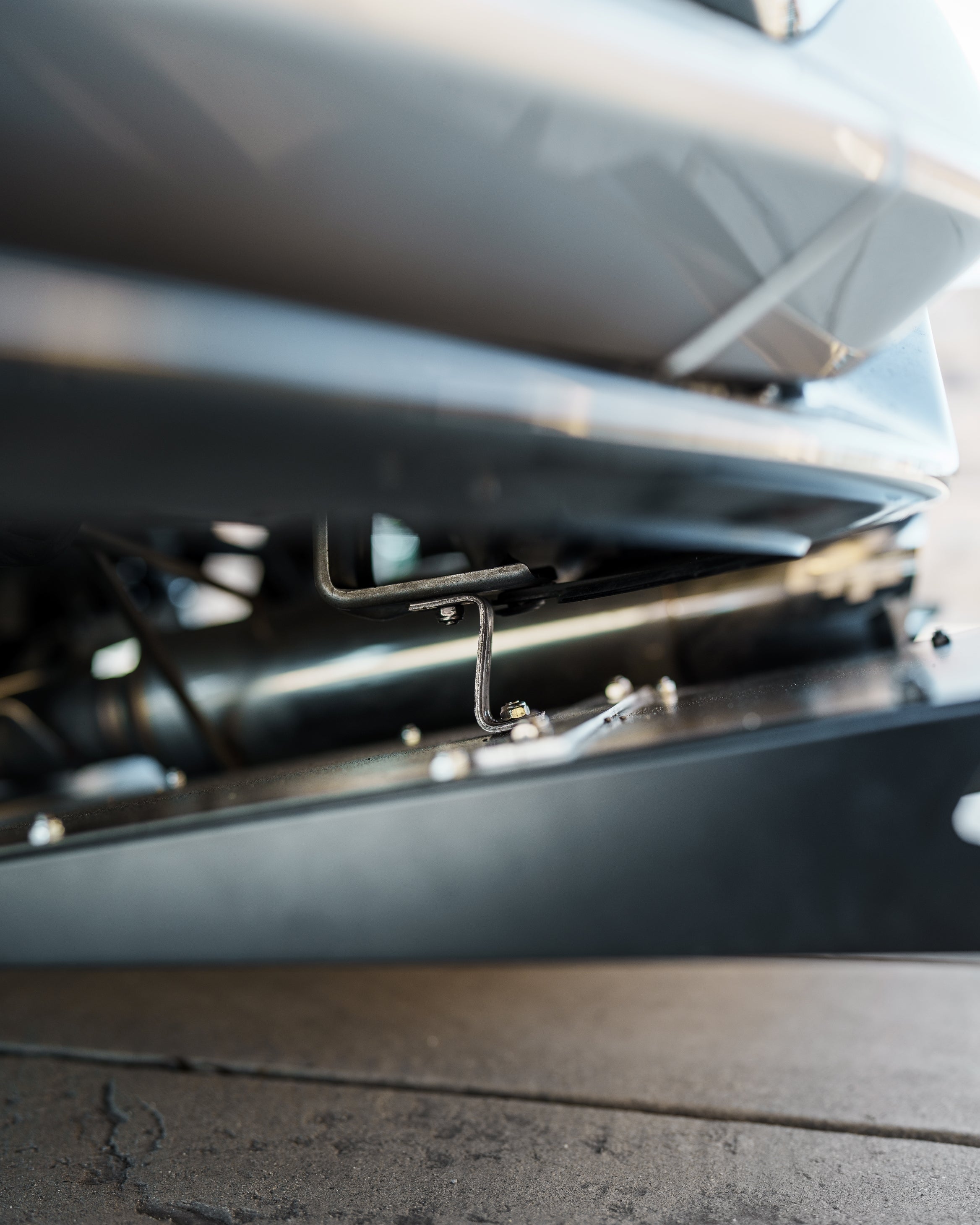 Close-up of the V1C+ diffuser mounting hardware along the Civic FK7 underbody