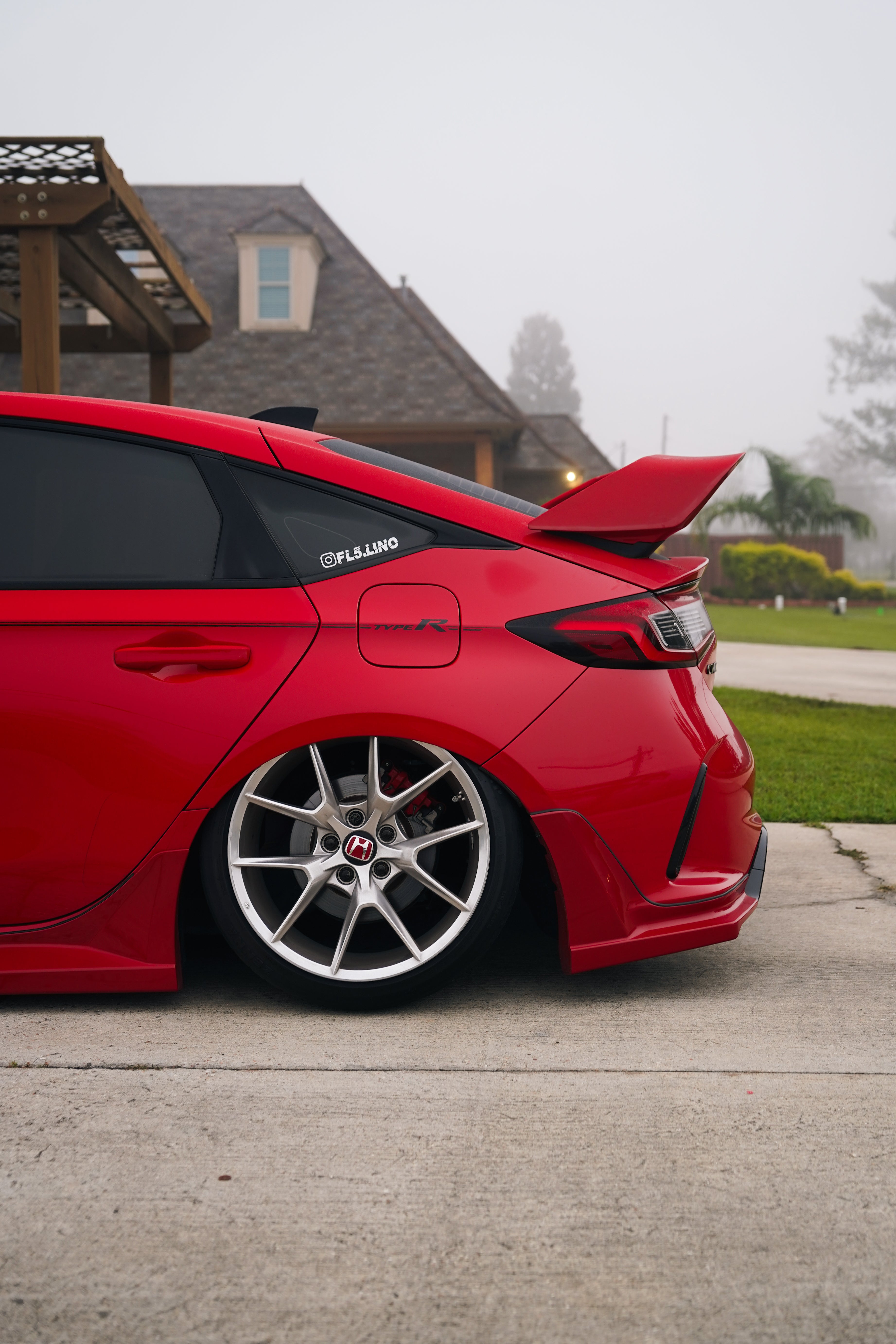 Side-rear view of a red Honda Civic FL5 with the Epsilon+ Sport Wing
