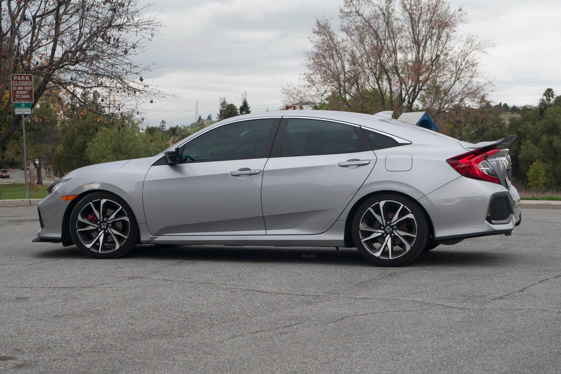 Side view of a silver Civic Si Sedan showing spoiler extension profile