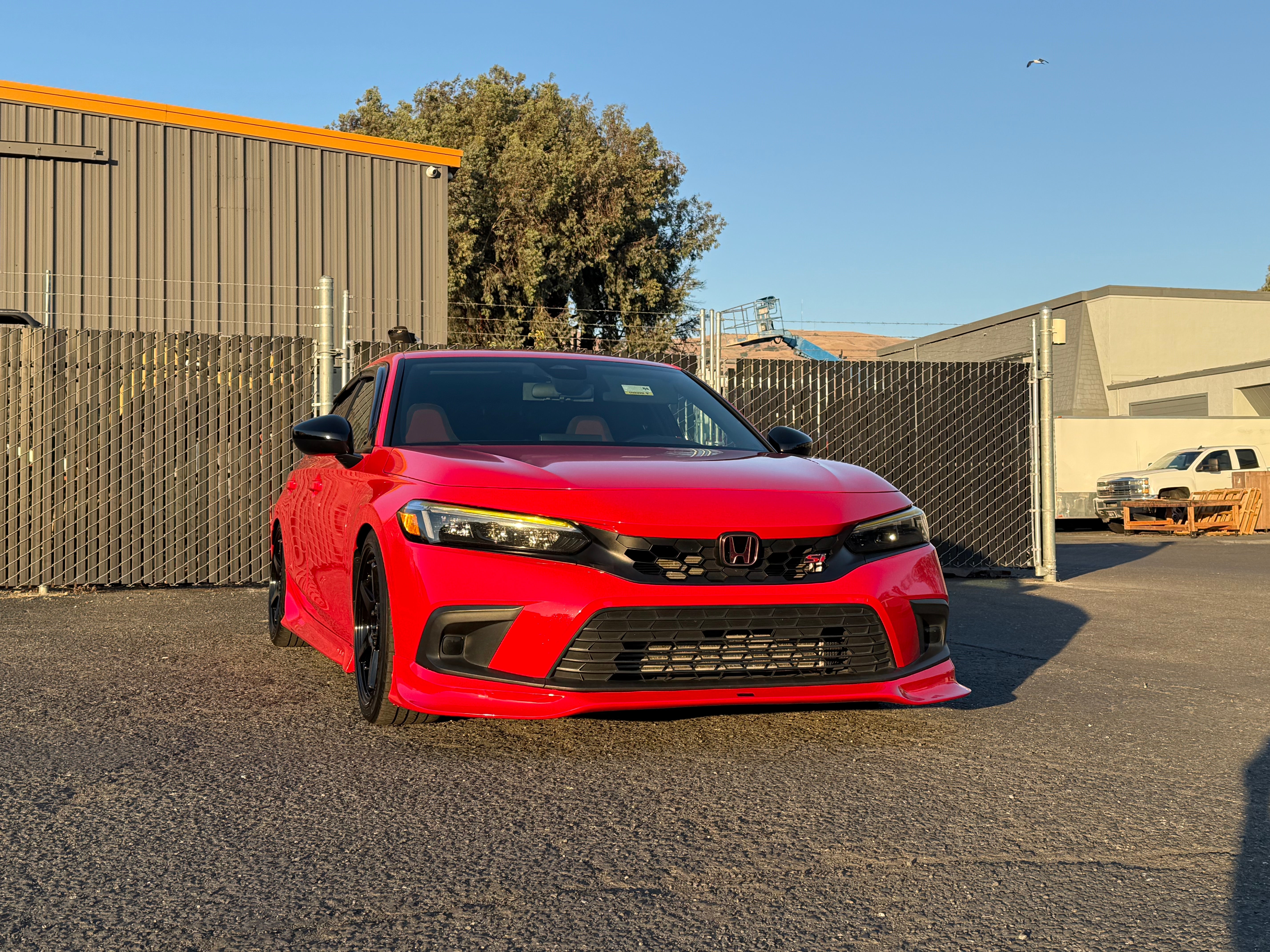 Front three-quarter view of a red Honda Civic with the Epsilon+ front lip
