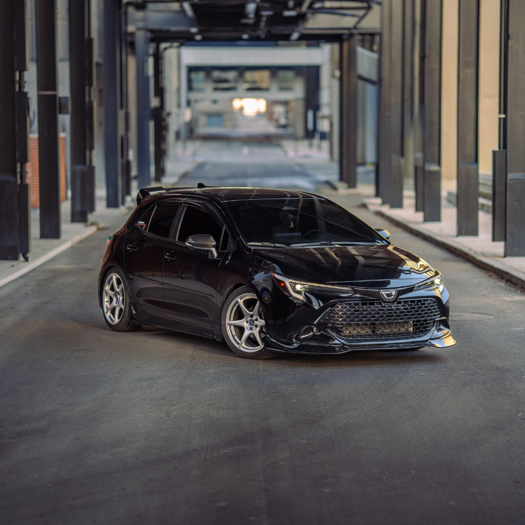 Black Toyota Corolla Hatchback with the Epsilon+ aero kit in a parking structure