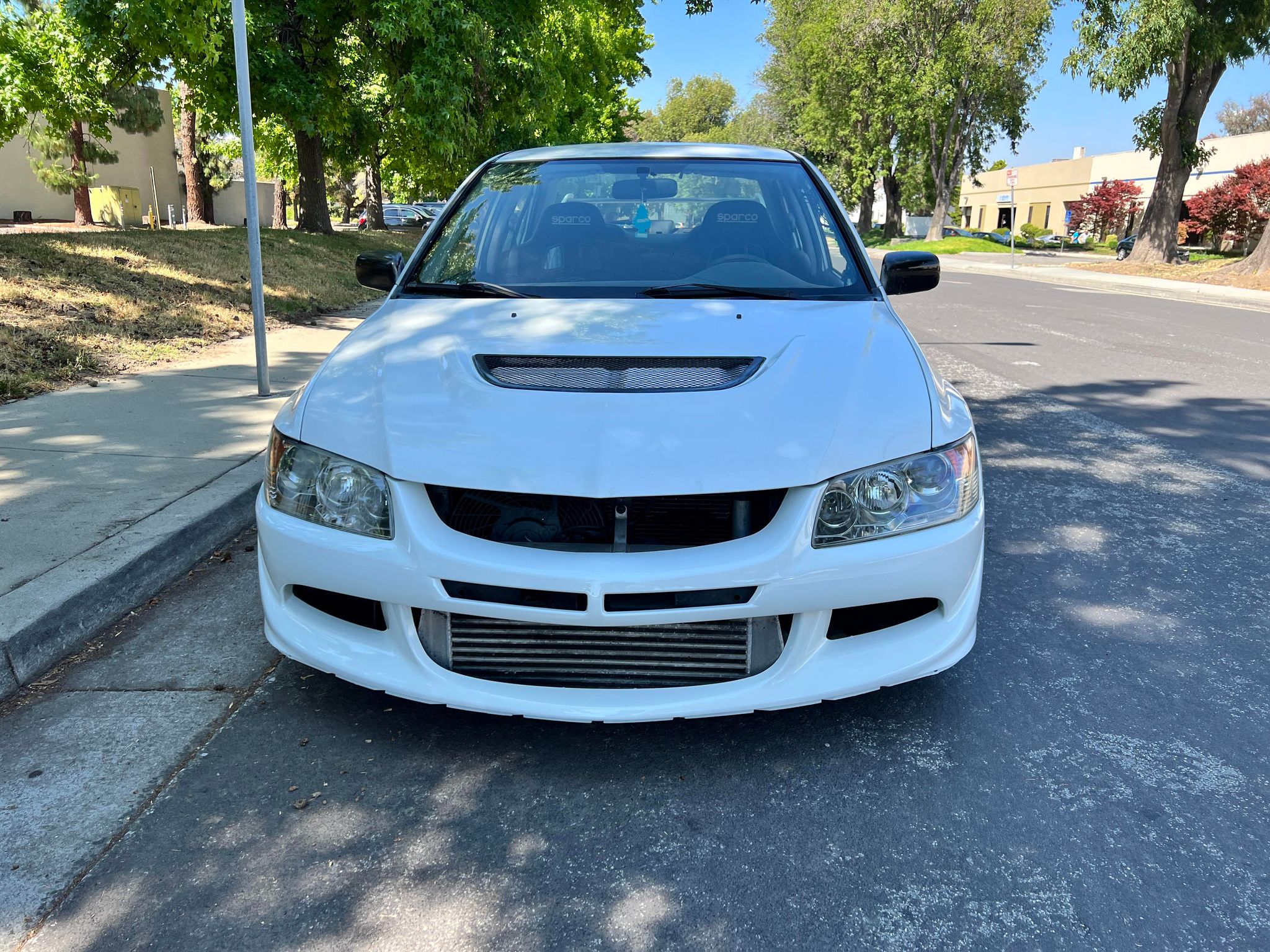 Close front view of the Epsilon+ front bumper on a white Mitsubishi Evo 8