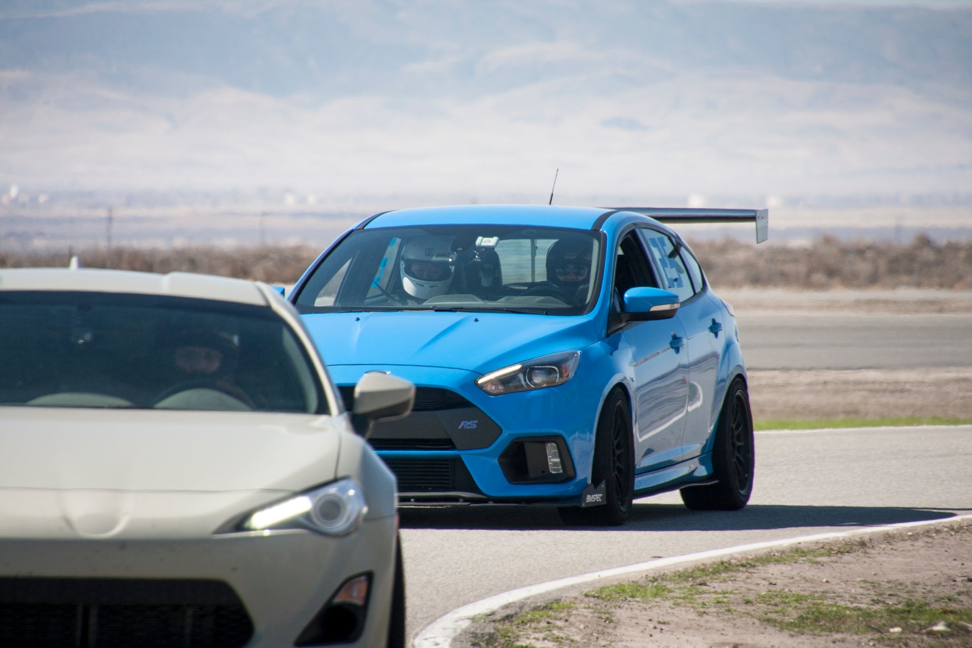 Rear view of a blue Focus RS motorsport car with GT wing on a track