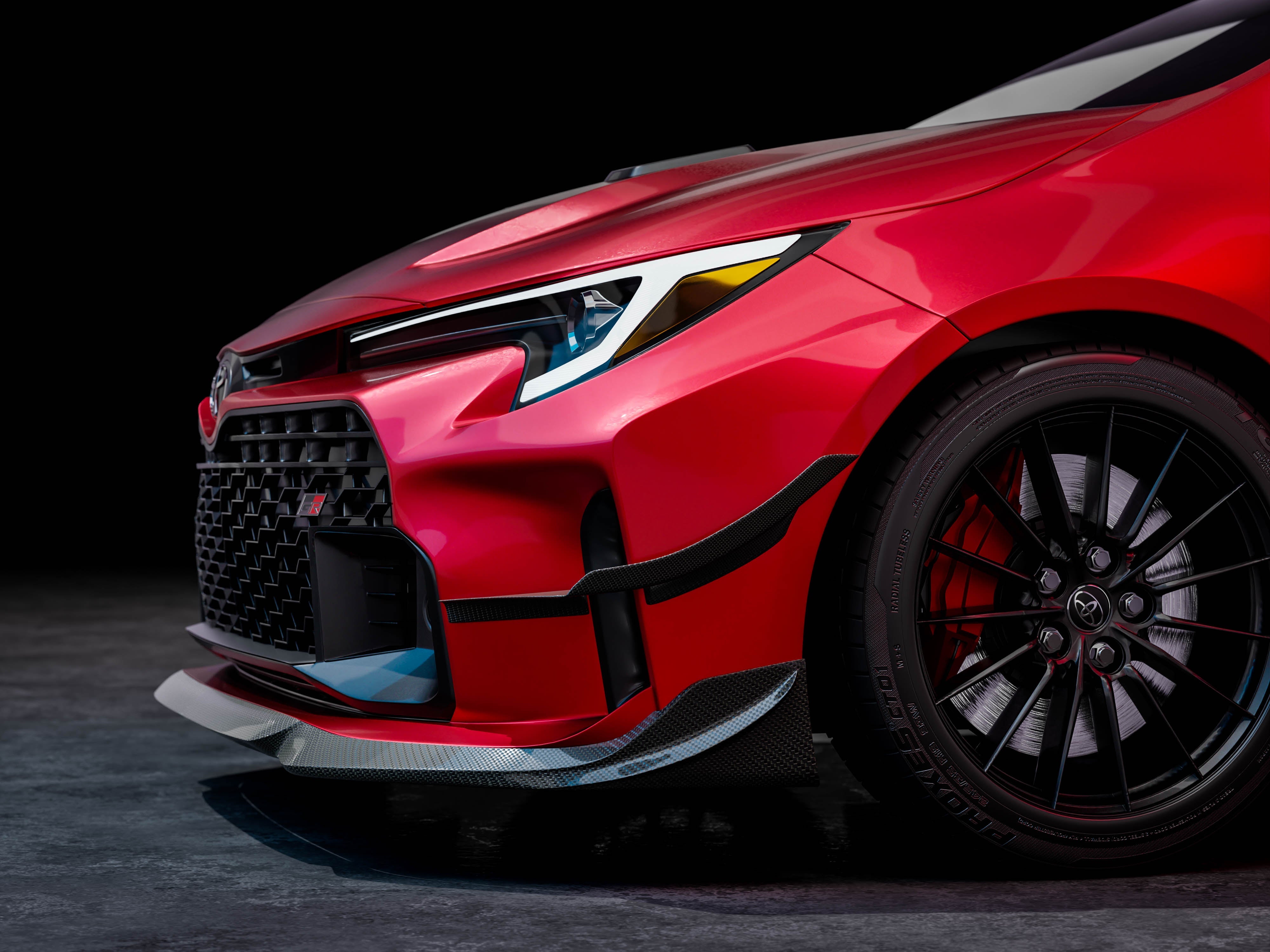 Close-up studio render of the canard and front bumper on a red GR Corolla