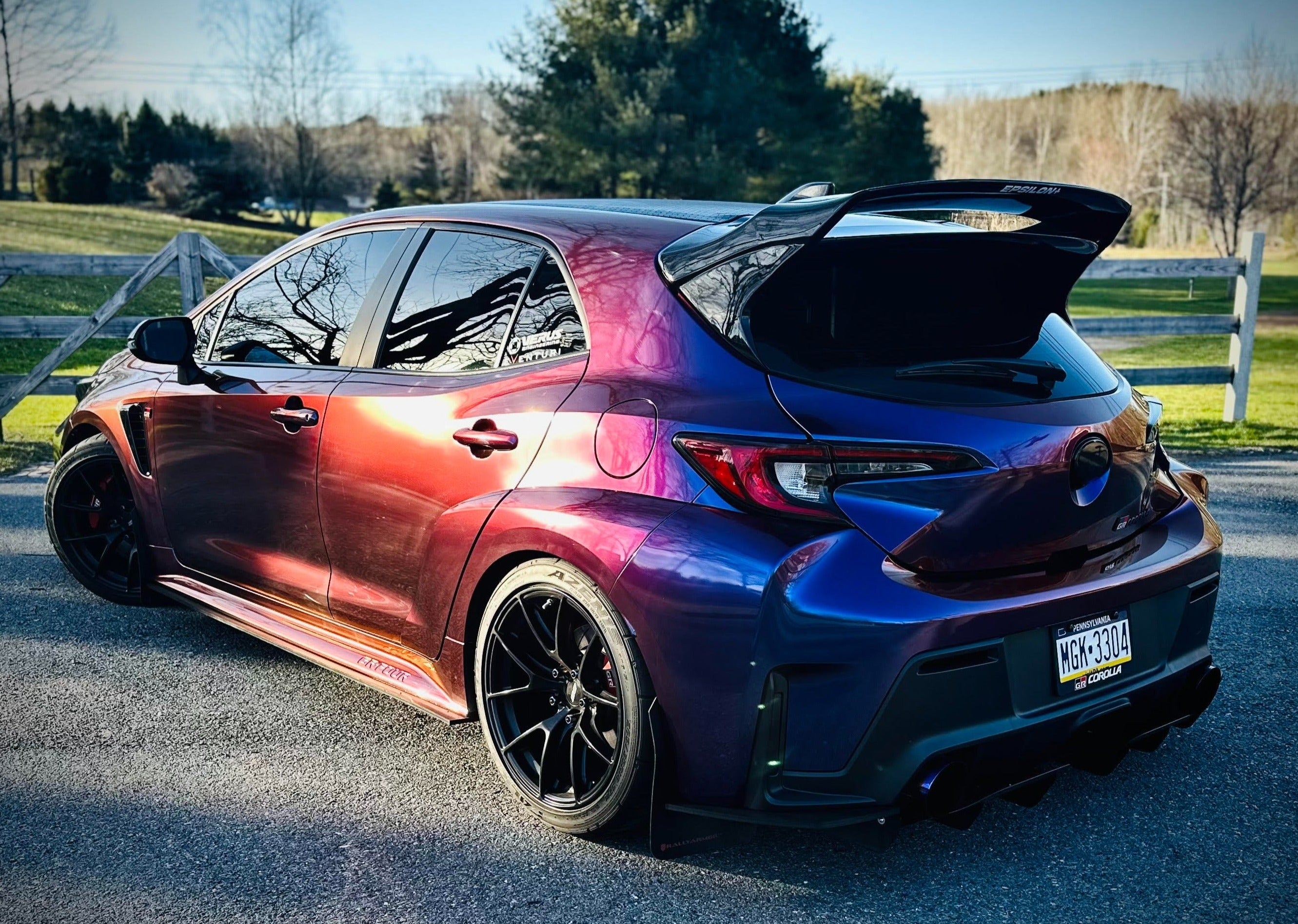 Side rear view of a purple color-shift GR Corolla with WRC Wing V3