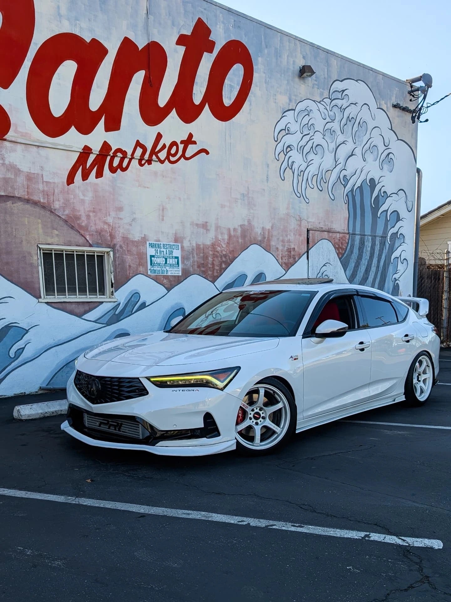 Front three-quarter view of a white Acura Integra with the Epsilon+ front lip