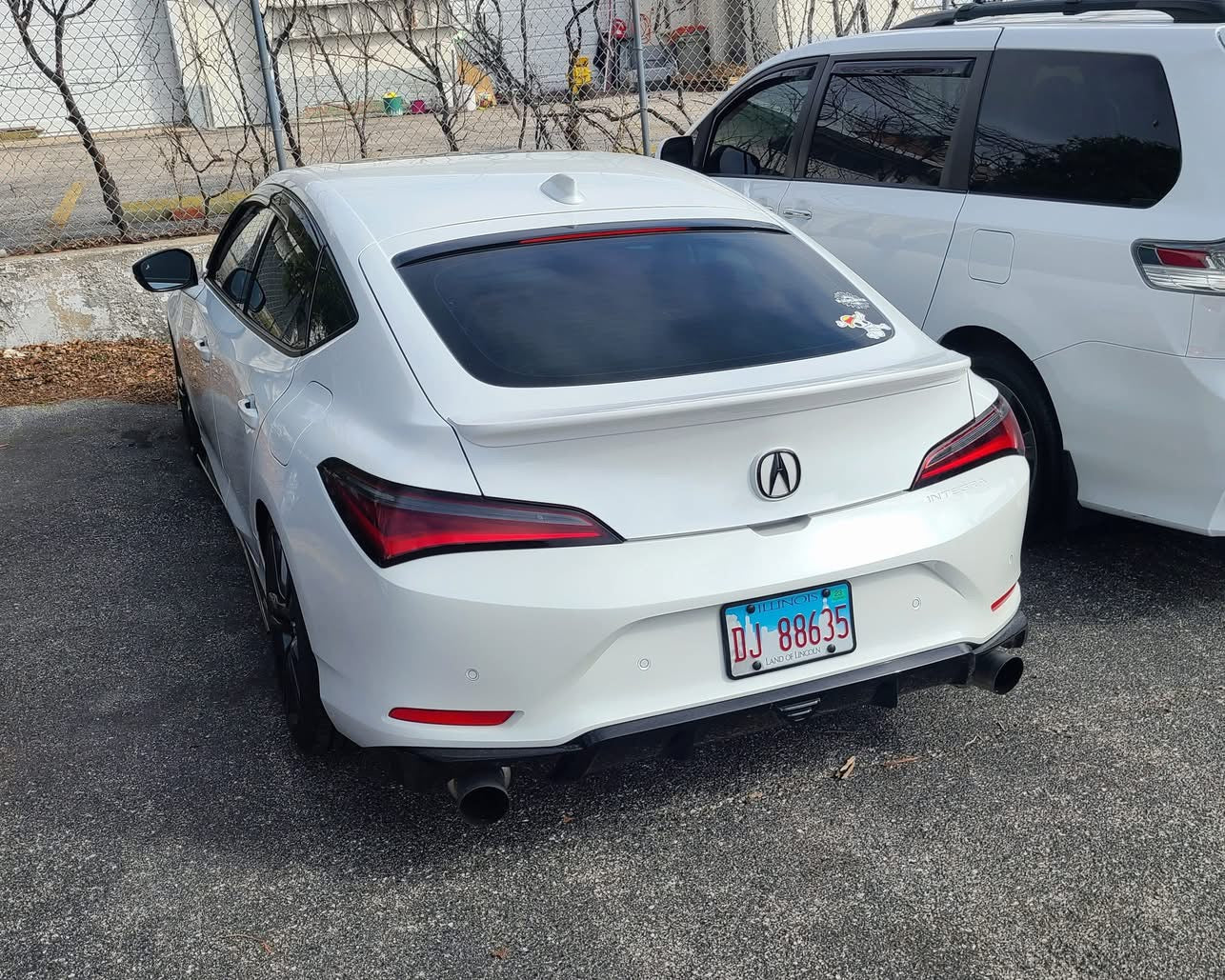 White Acura Integra with the rear trunk lip parked at a car wash