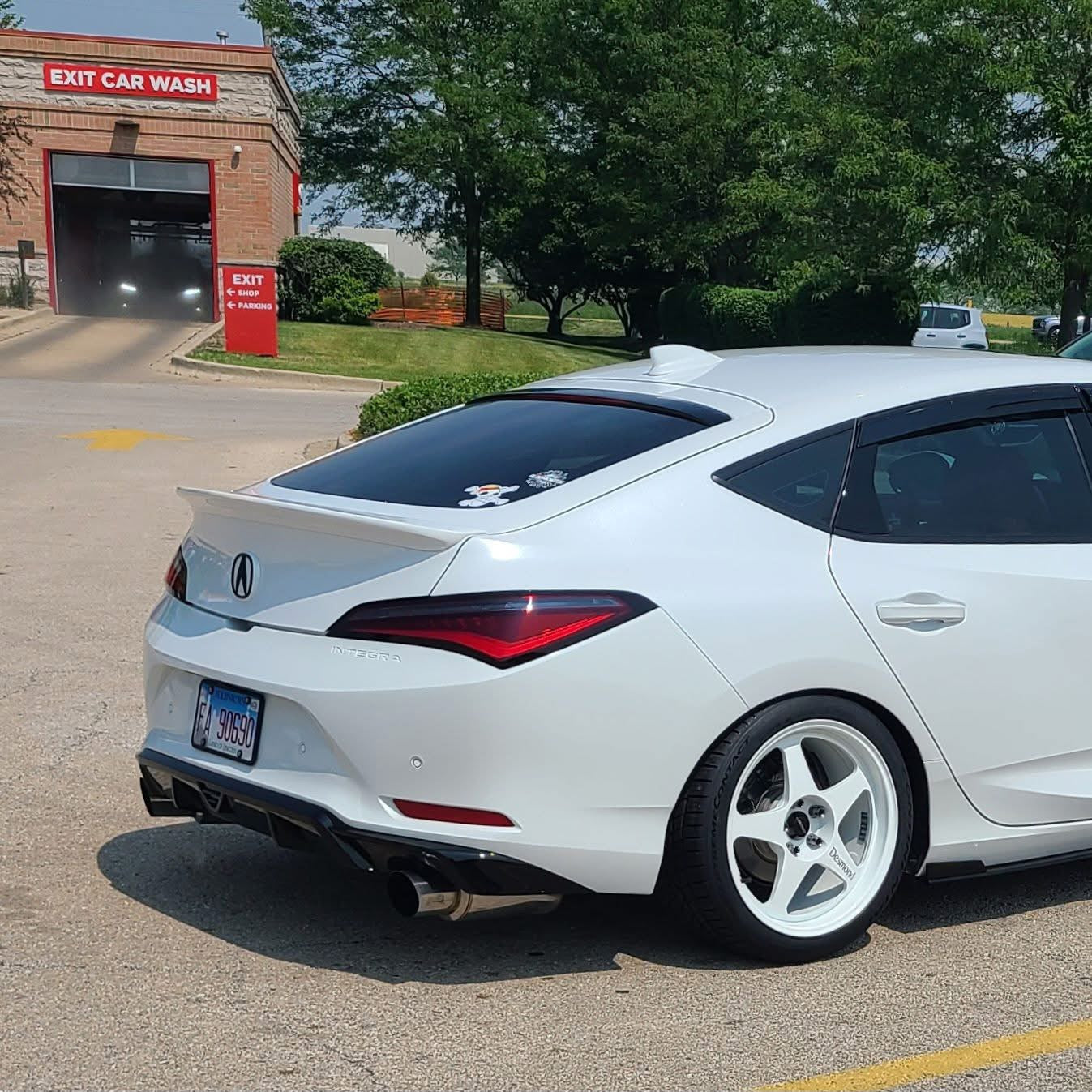 Side-rear view of a white Acura Integra with the Epsilon+ rear trunk lip