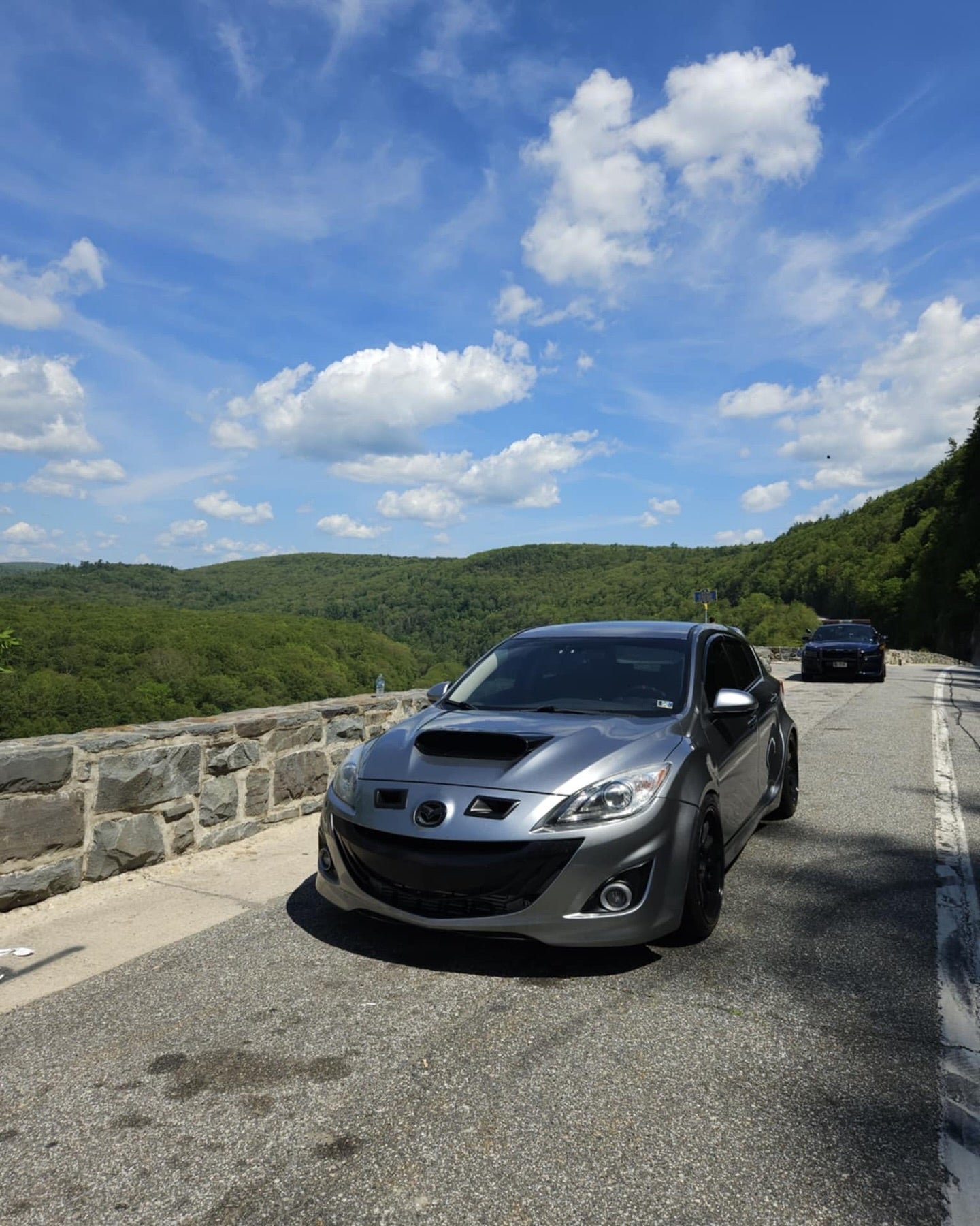 Front view of a grey Mazdaspeed3 BL fitted with widebody fender flares