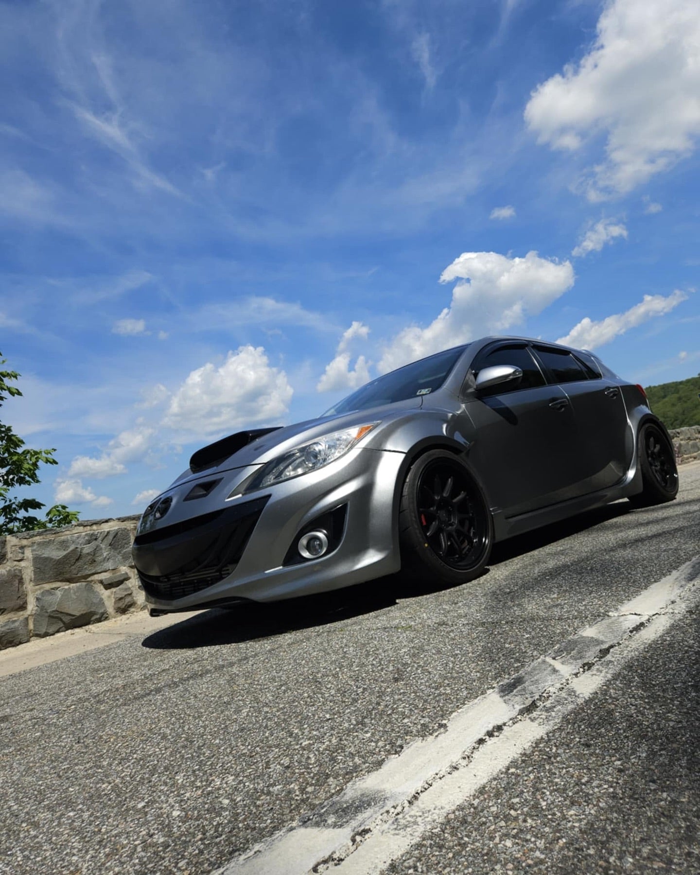 Grey Mazdaspeed3 BL with widebody fender flares, front three-quarter view