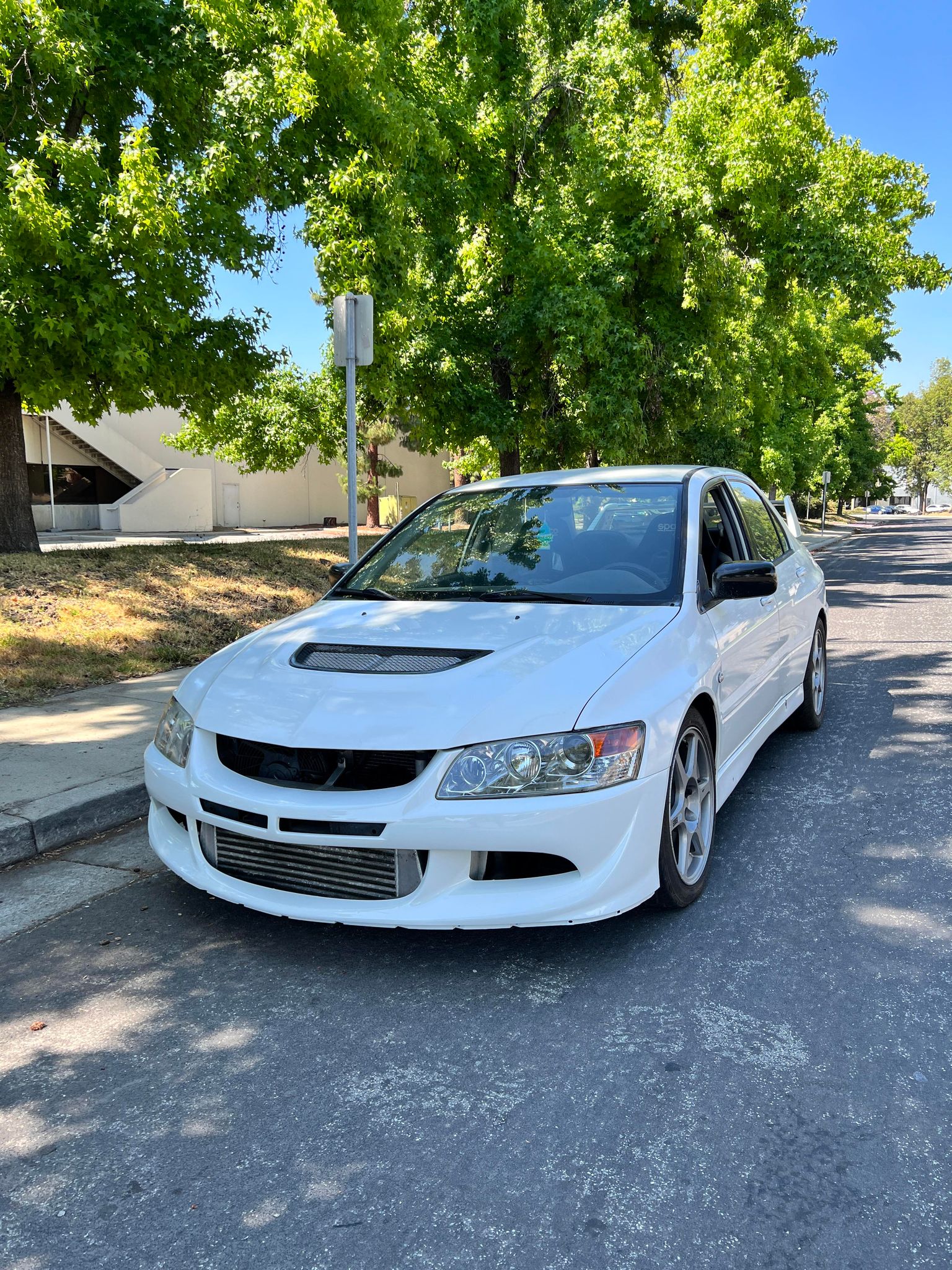 Front three-quarter view of a white Mitsubishi Evo 8 with the Epsilon+ front bumper