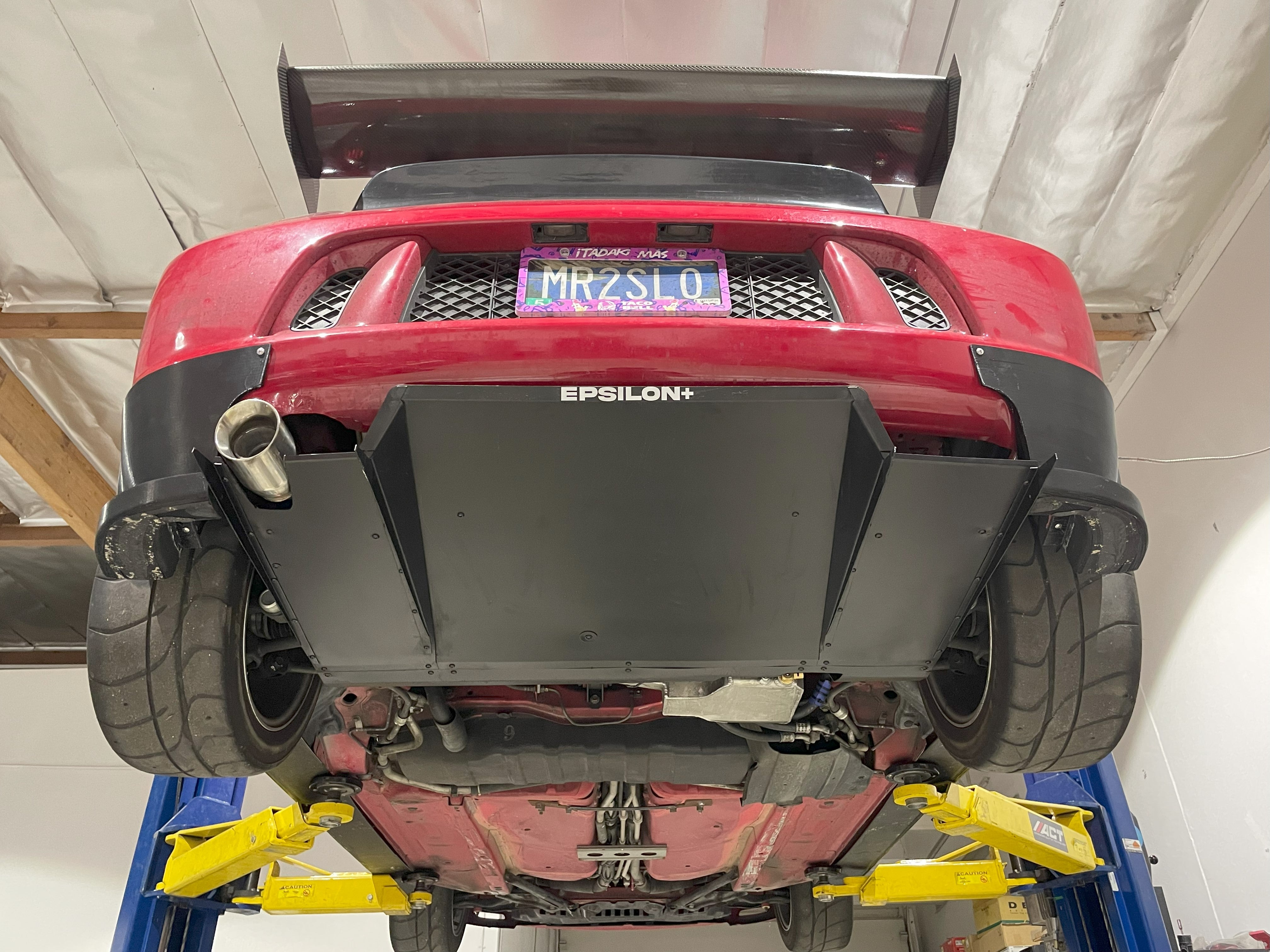 Underbody angle showing the V1+ diffuser and exhaust routing on an MR2 Spyder