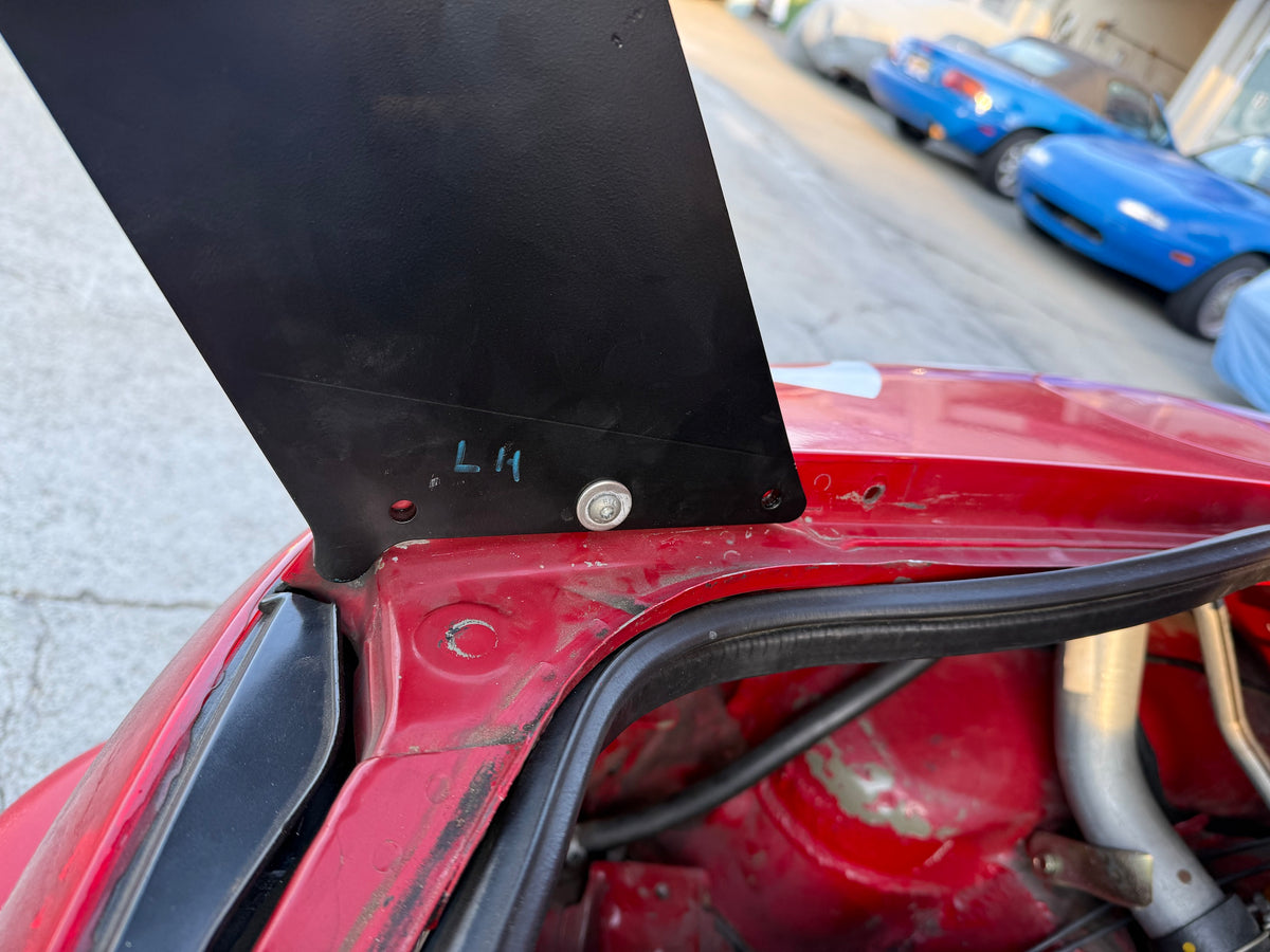 Close-up of TC Wing upright mounting hardware on an NA Miata trunk lid