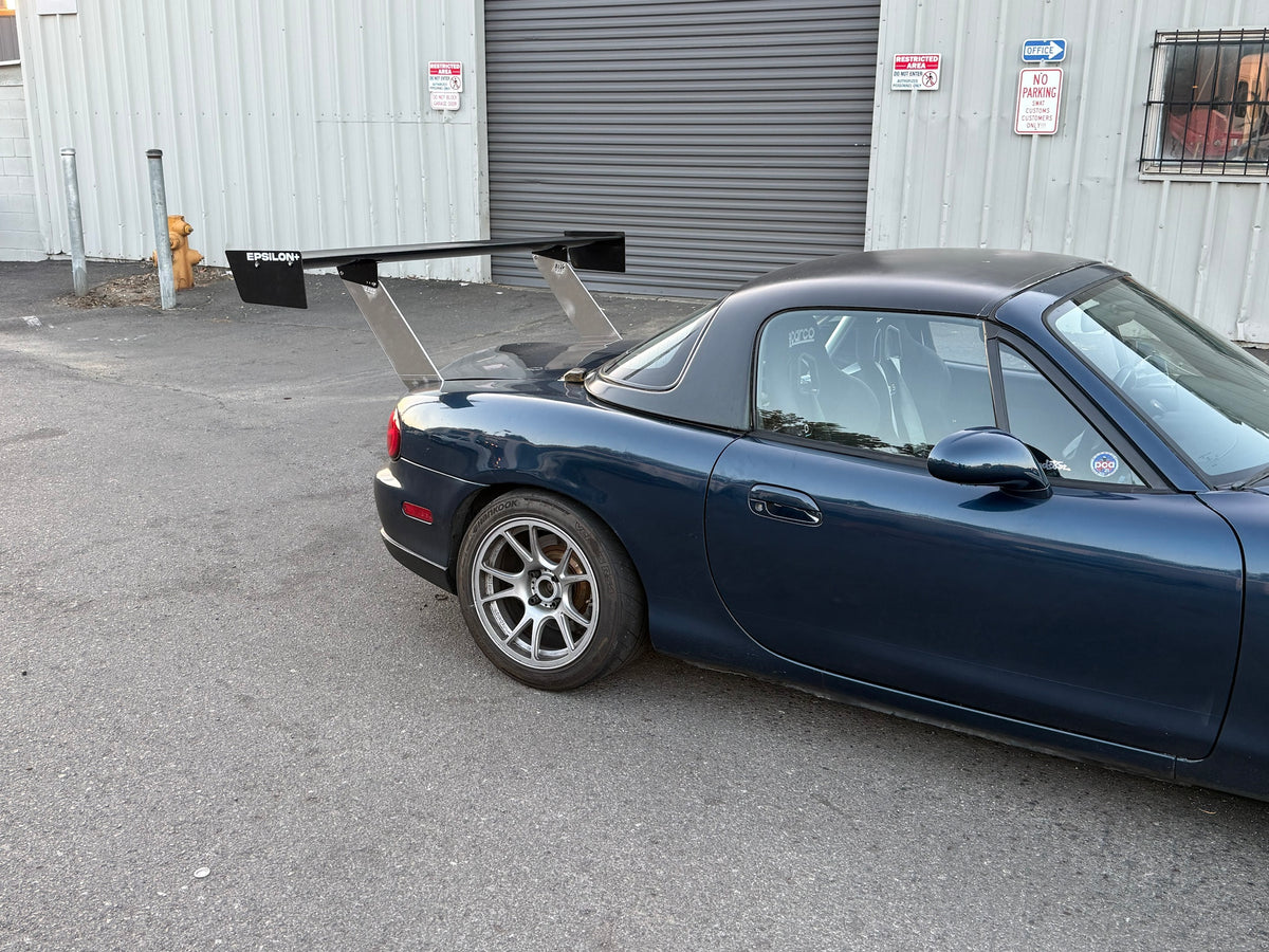 Side view of a dark blue Mazda Miata NB hardtop with the Epsilon+ TC wing