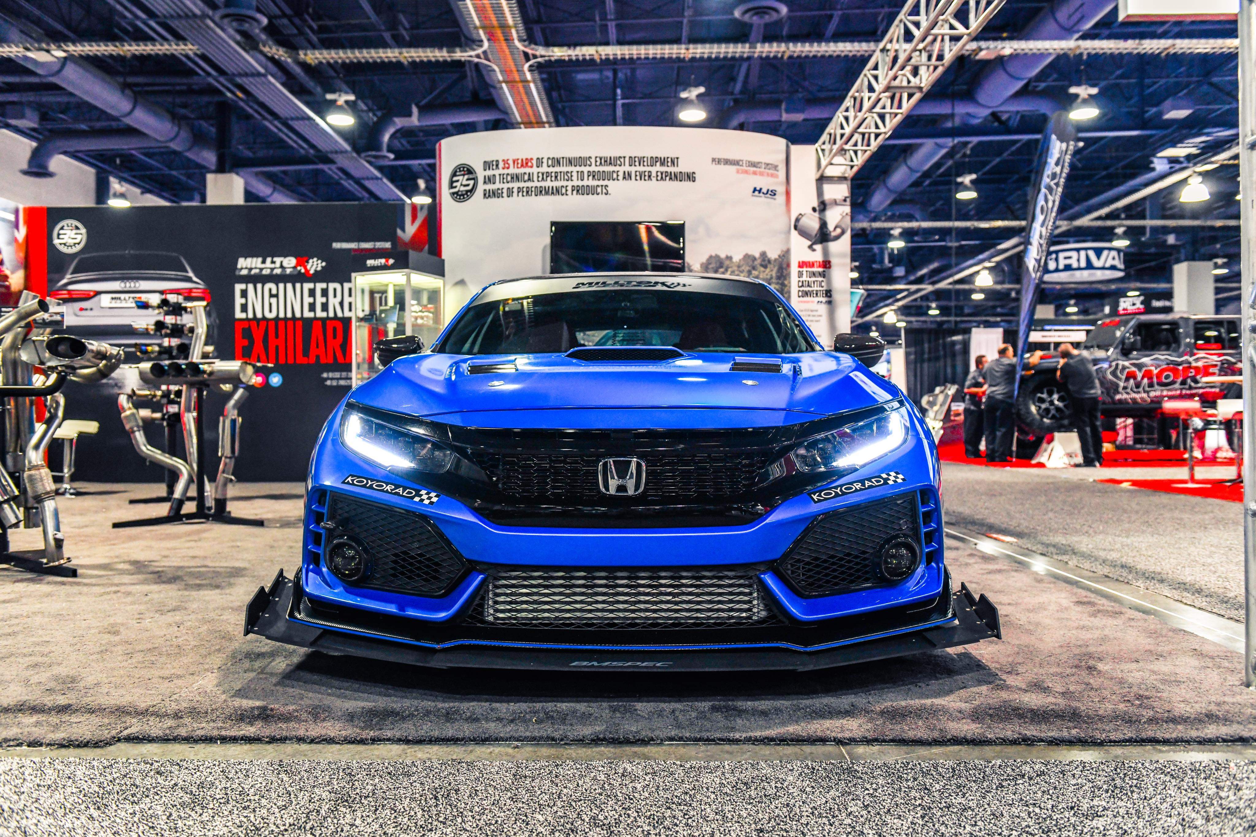 Front view of a blue Civic Type R FK8 with front splitter on display at a car show