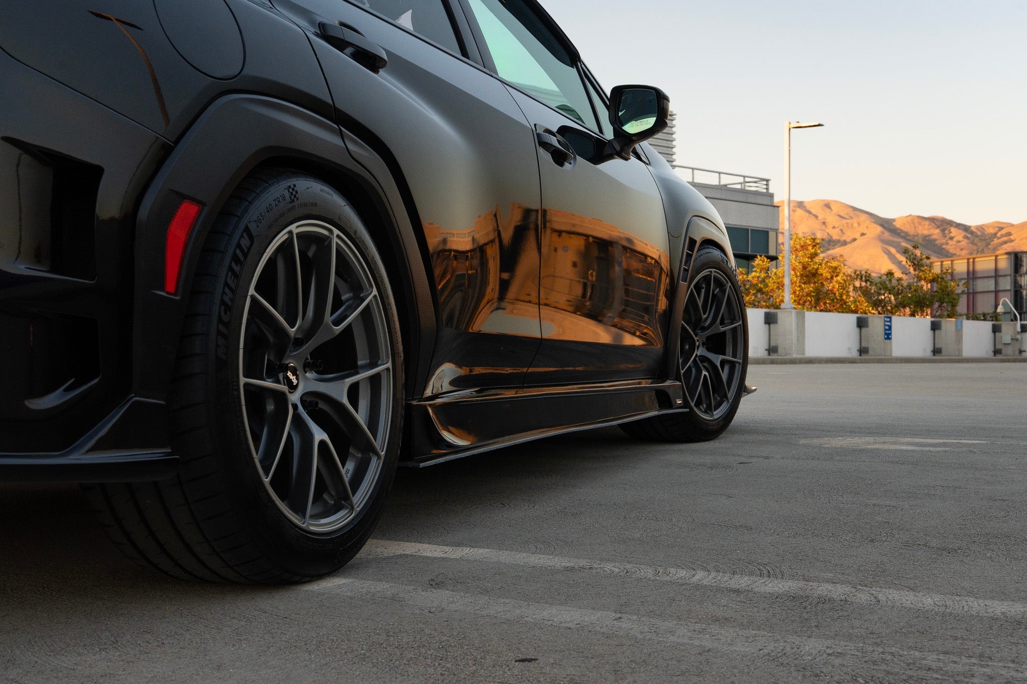 Close-up of the side skirt on a black Subaru WRX VB at a parking structure