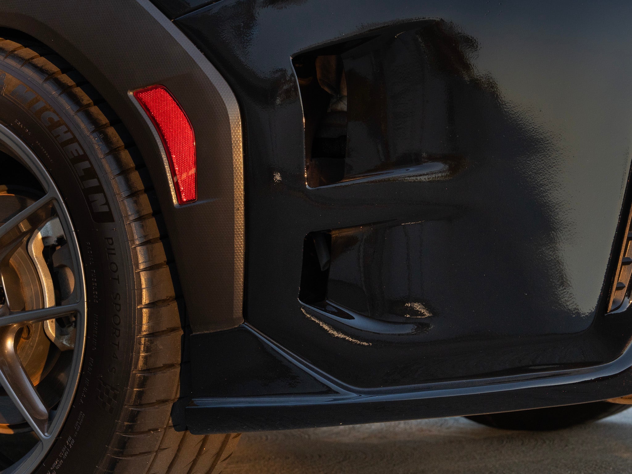 Close-up of the rear bumper vent detail on a black Subaru WRX VB