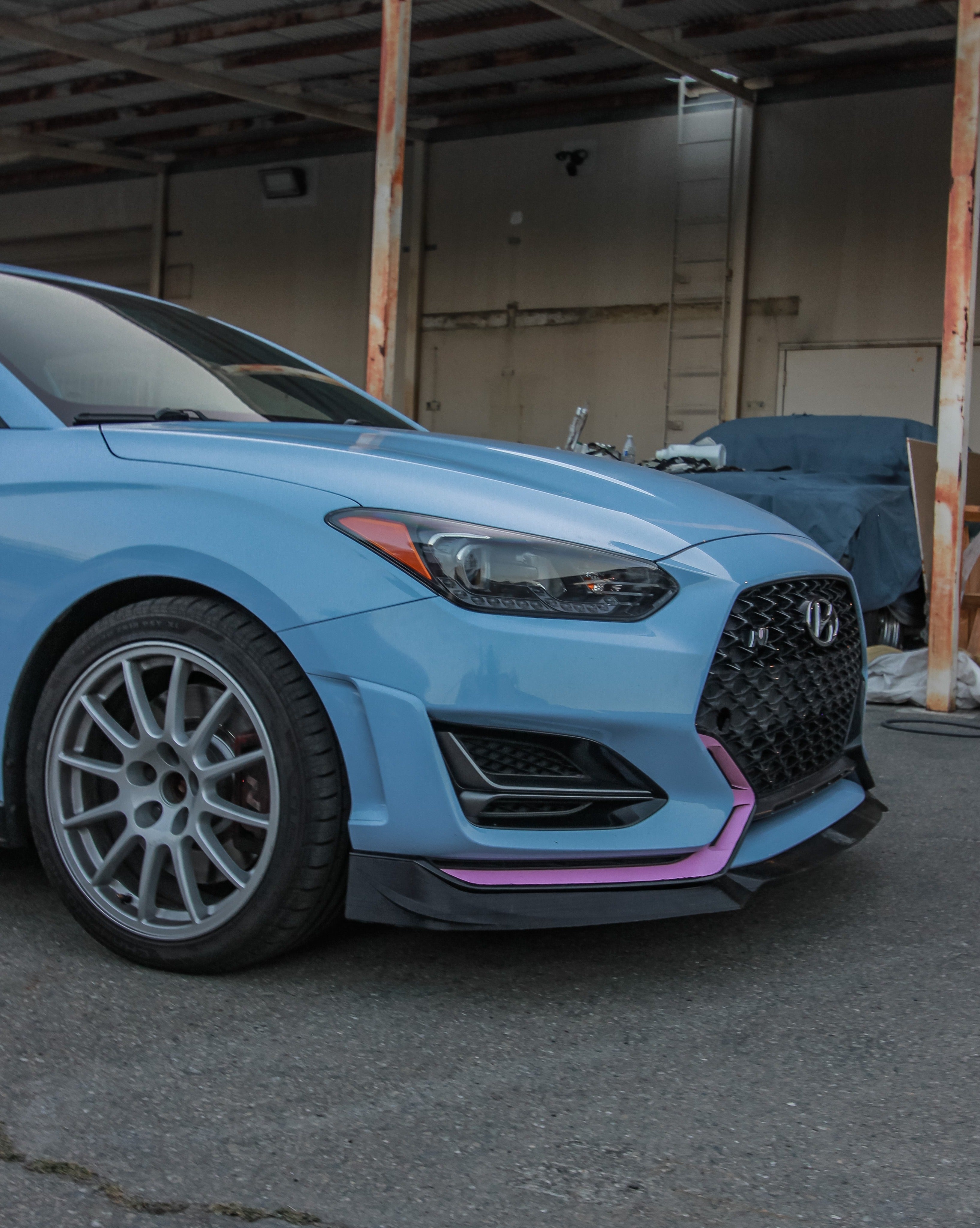 Front corner view of a Hyundai Veloster N with the front lip and side splitter