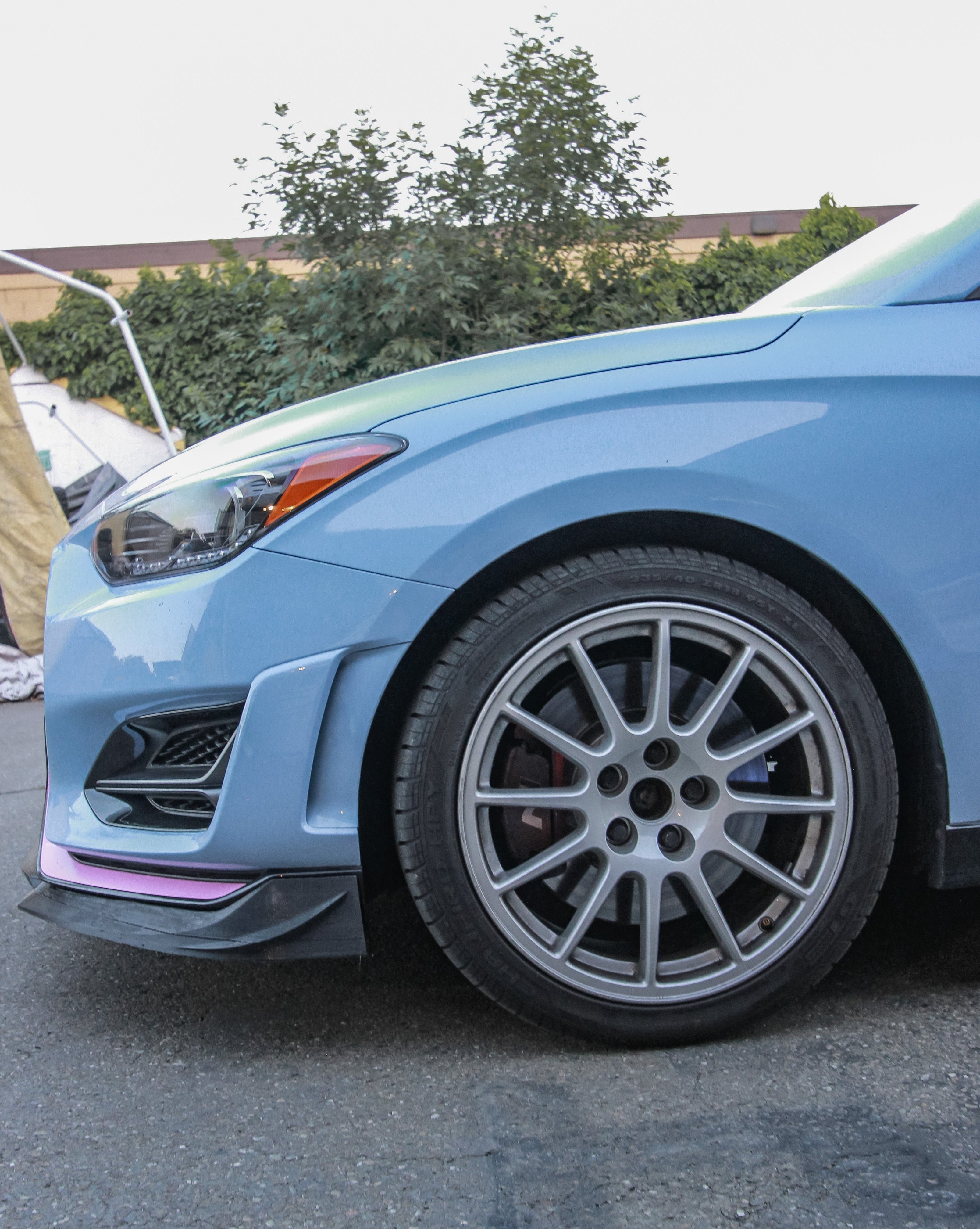 Front lip corner and wheel detail on a Hyundai Veloster N