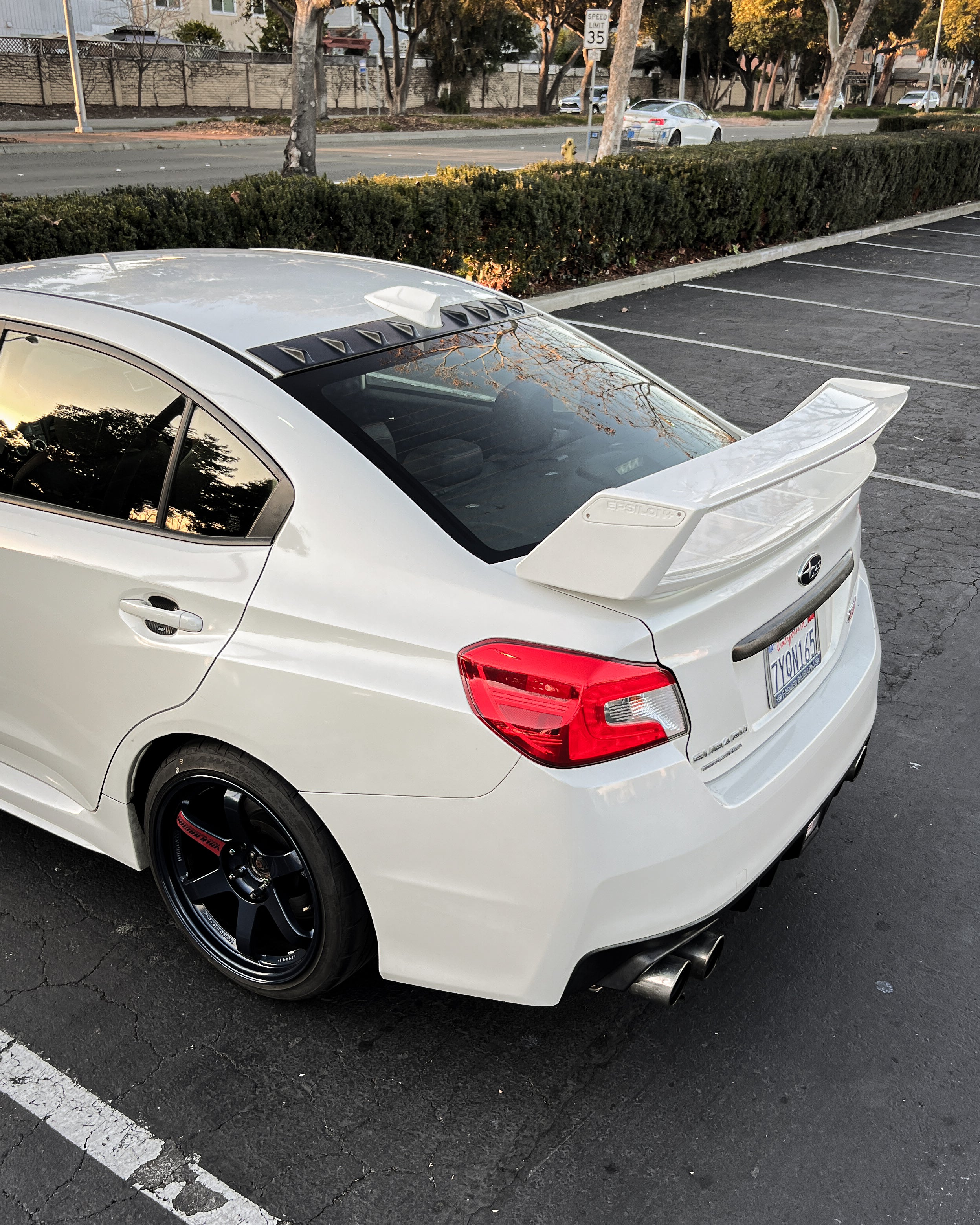 White Subaru WRX VA with the WRC wing parked in a lot
