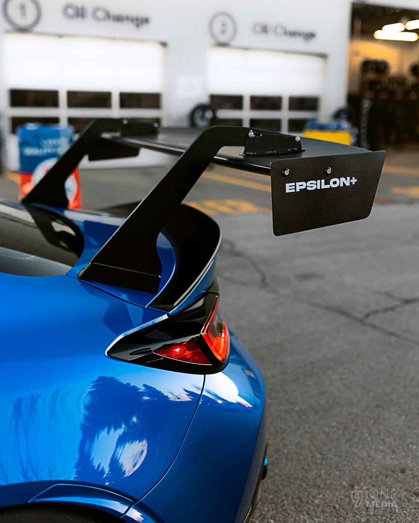 Close-up of the GT wing mount and endplate on a blue BRZ ZN8 trunk