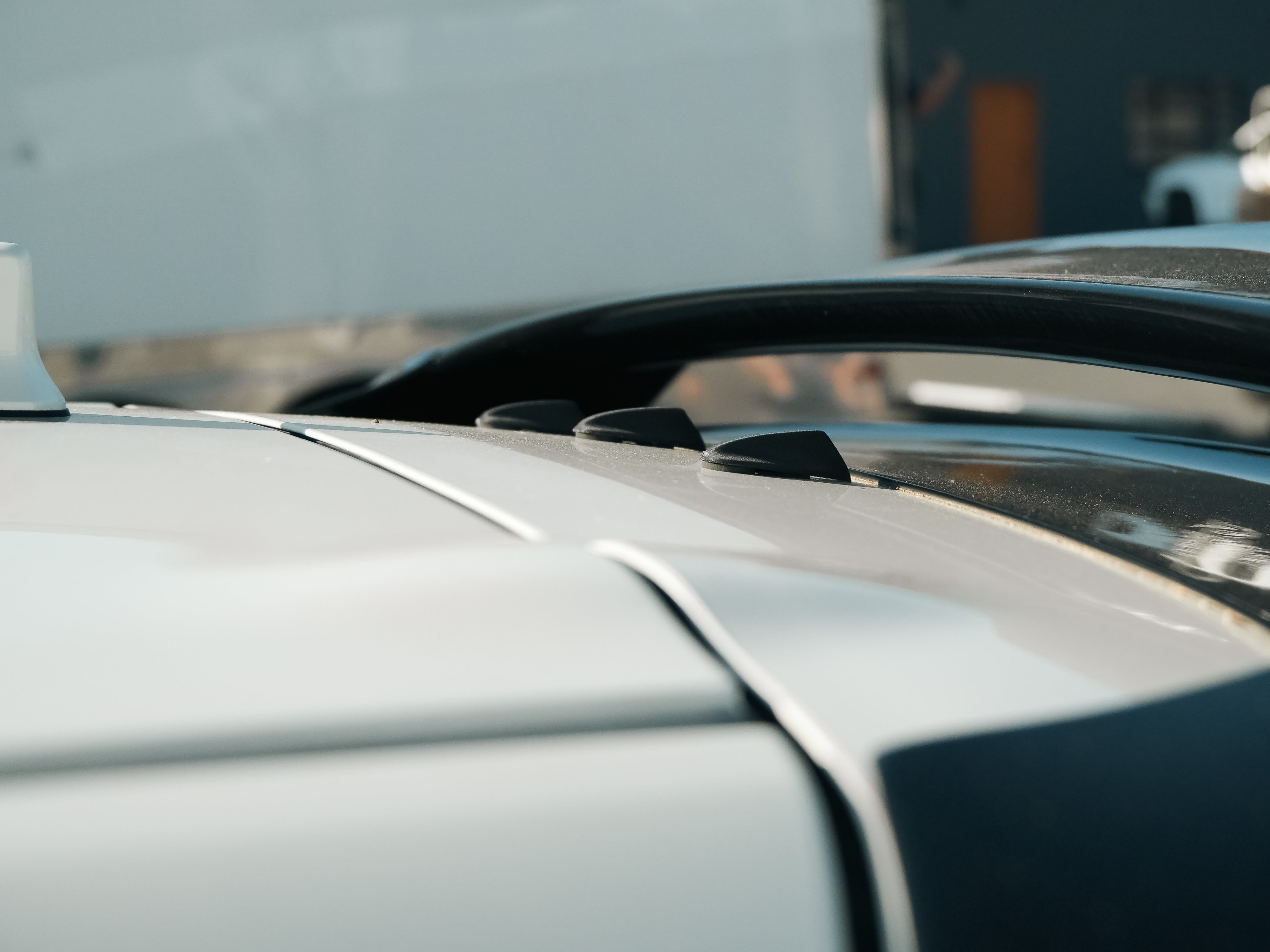 Close-up of vortex generator plugs on the roofline of a white GR Corolla