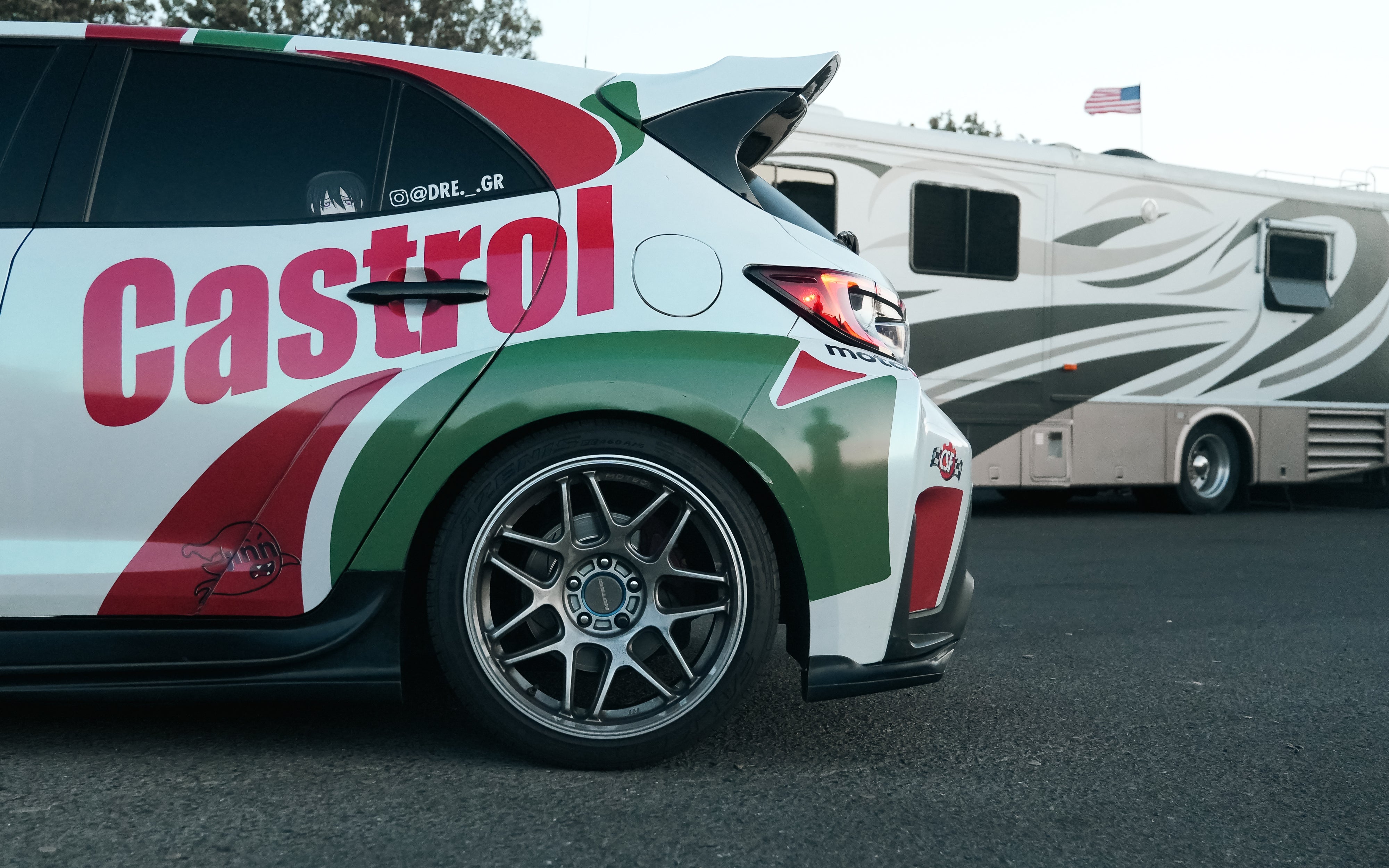 Rear three-quarter view of a white Castrol-livery GR Corolla rally car with rear spats V2