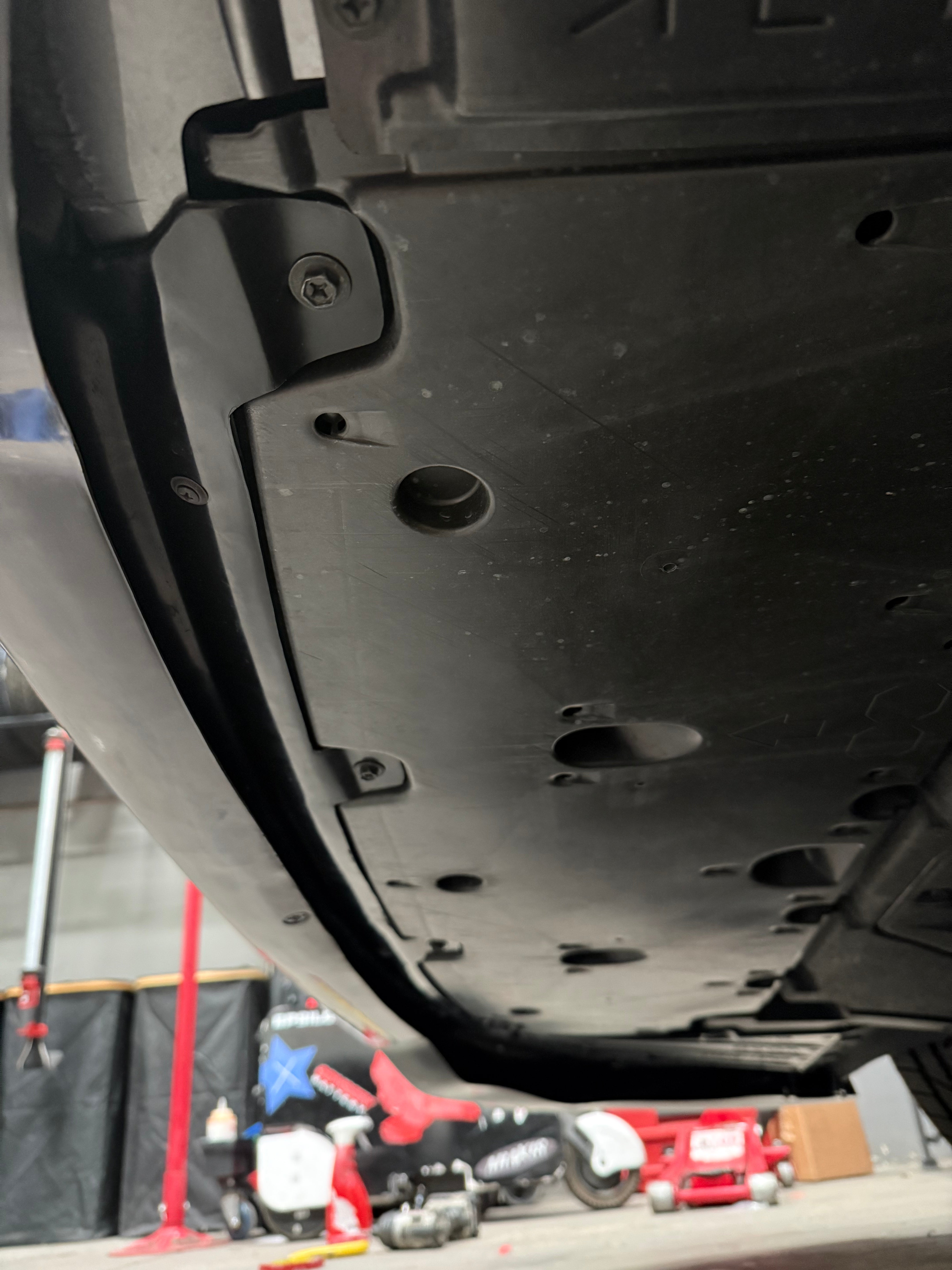 Close-up underside view of the front lip mount points on a GR Corolla Kouki
