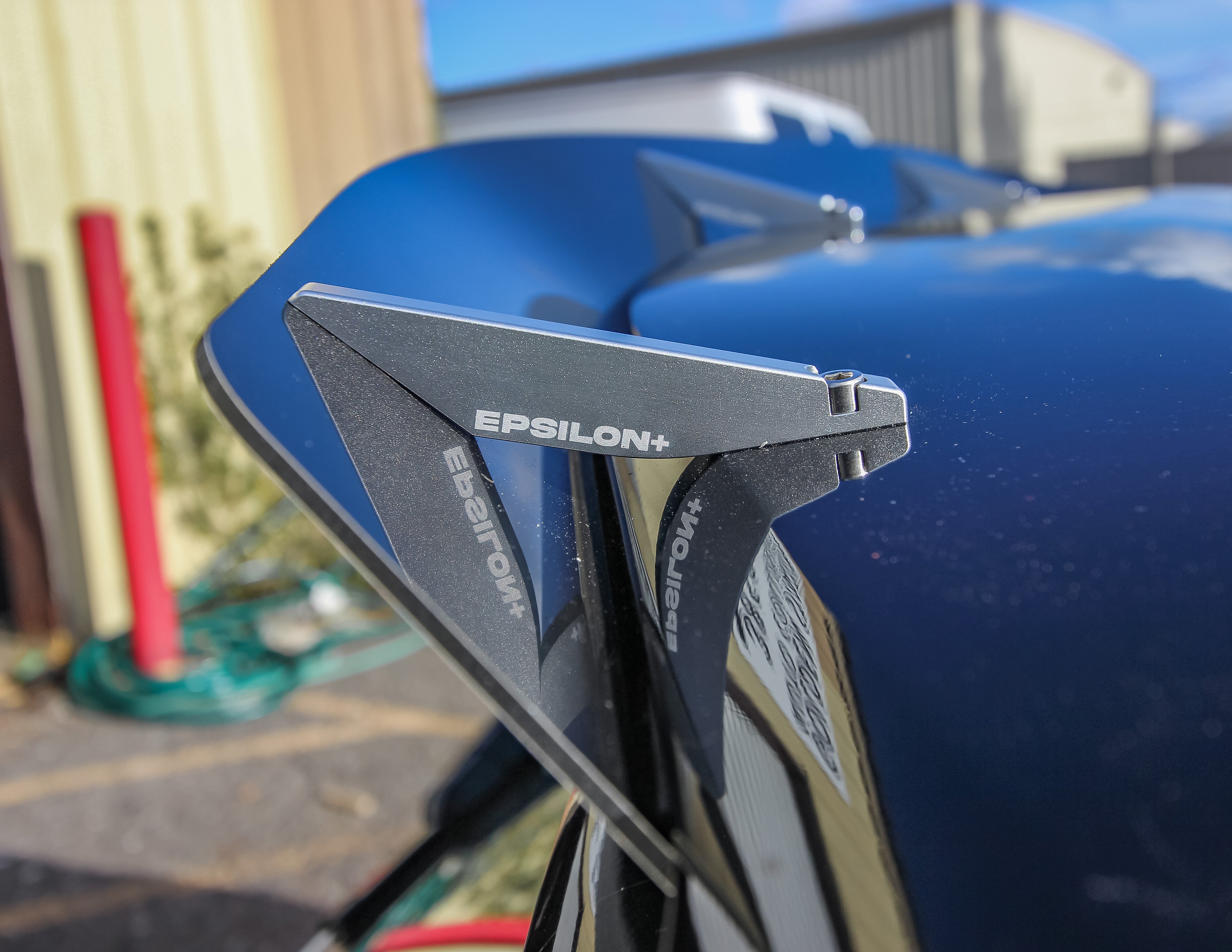 Close-up angle of the spoiler extension mounted on a blue Veloster N JS