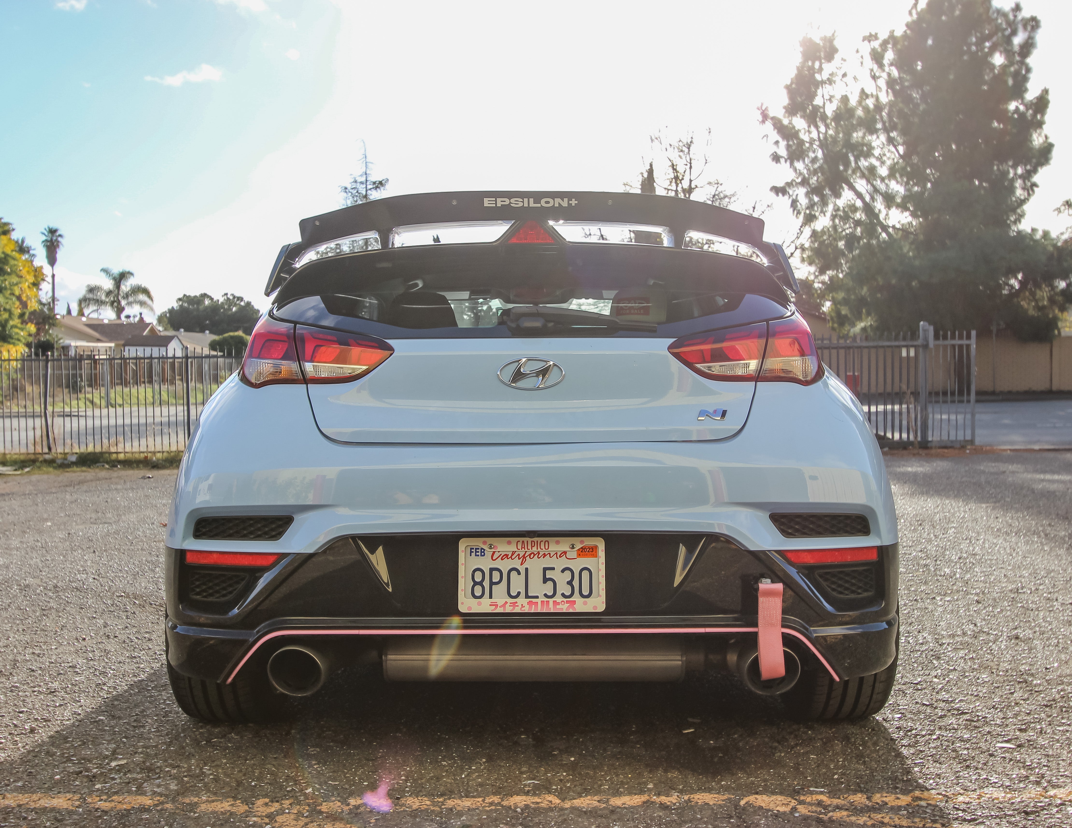 Rear view of a light blue Veloster N JS showing the spoiler extension and taillights