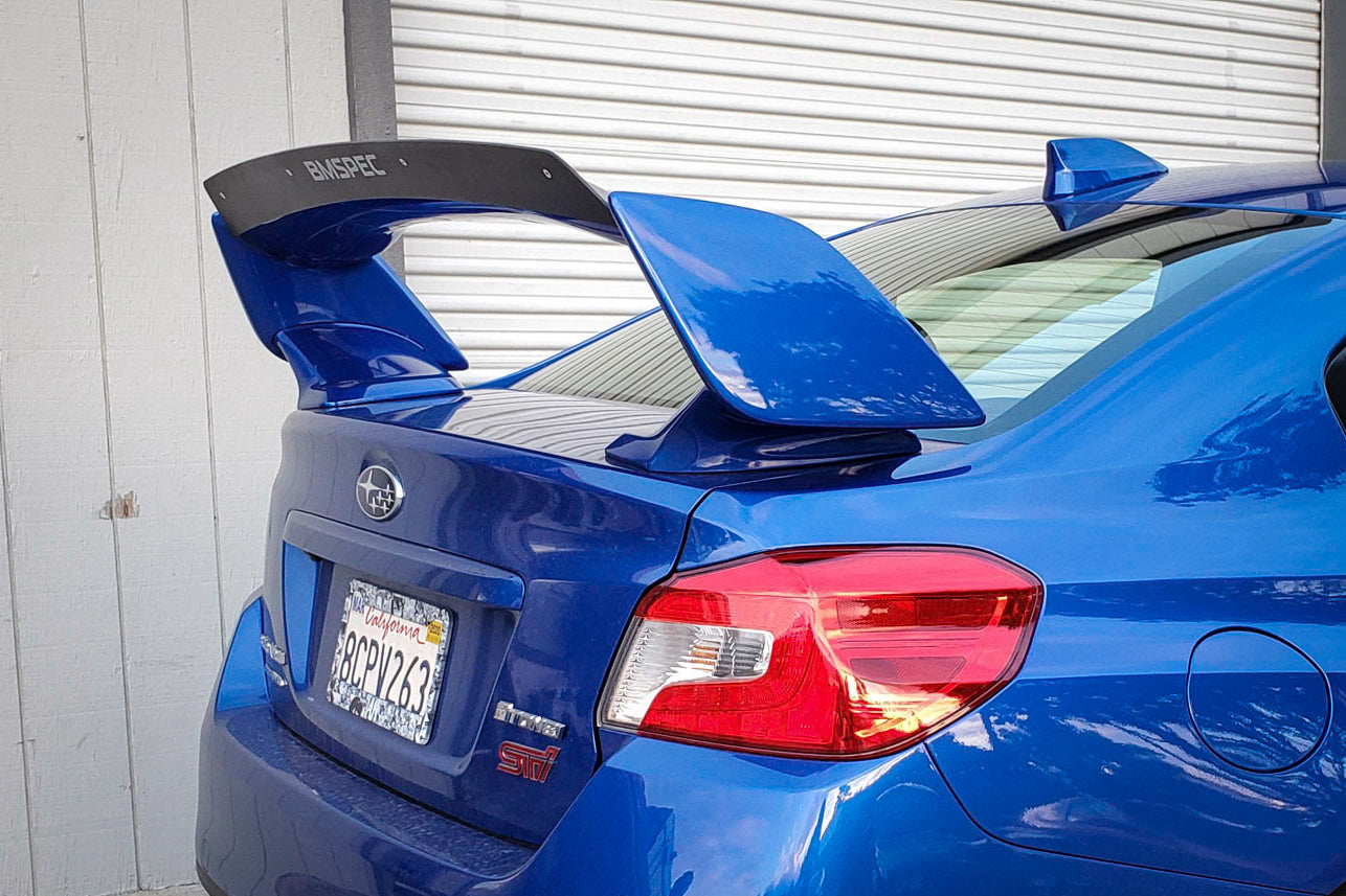 Rear view of a blue Subaru STI VA with spoiler extension on the trunk wing