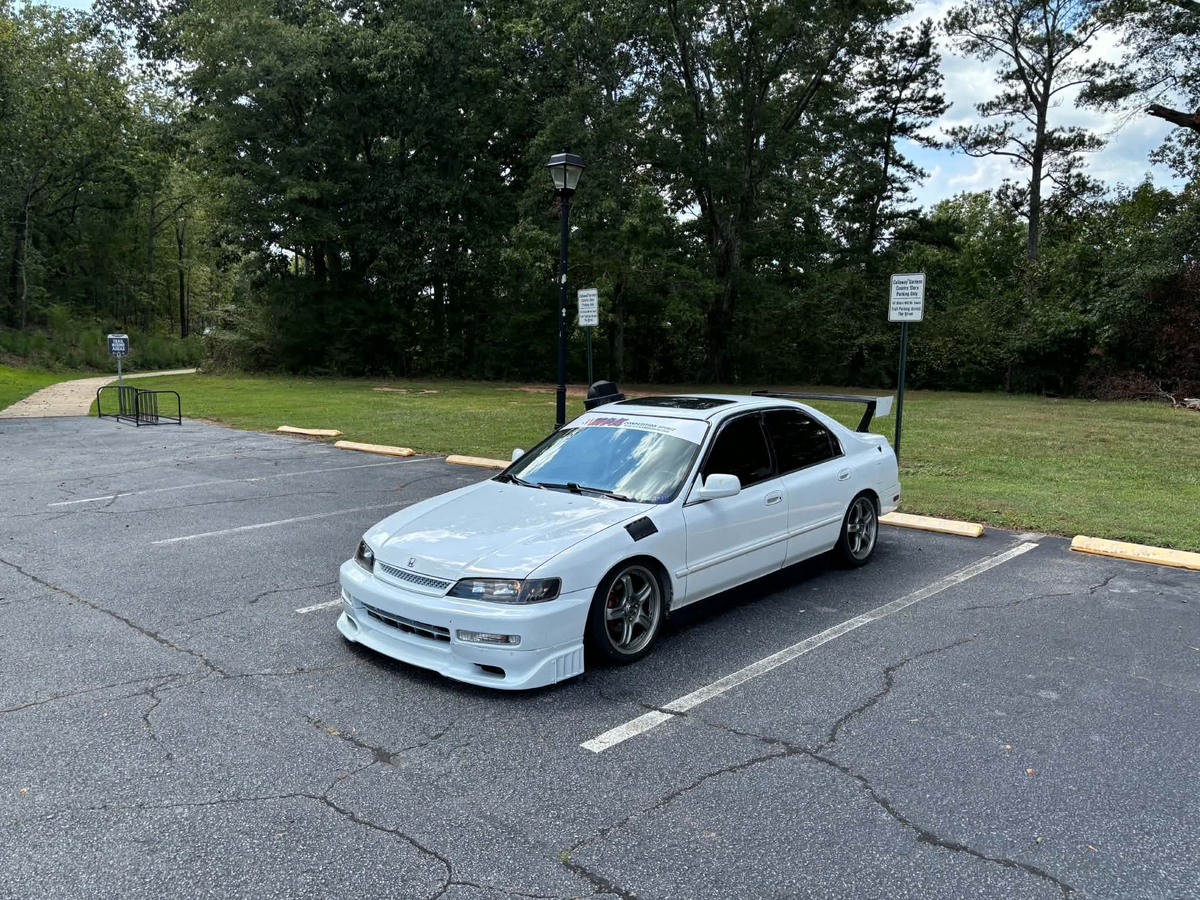 White Honda Accord CD5 with the Epsilon+ TC Wing installed, front three-quarter view in a parking lot