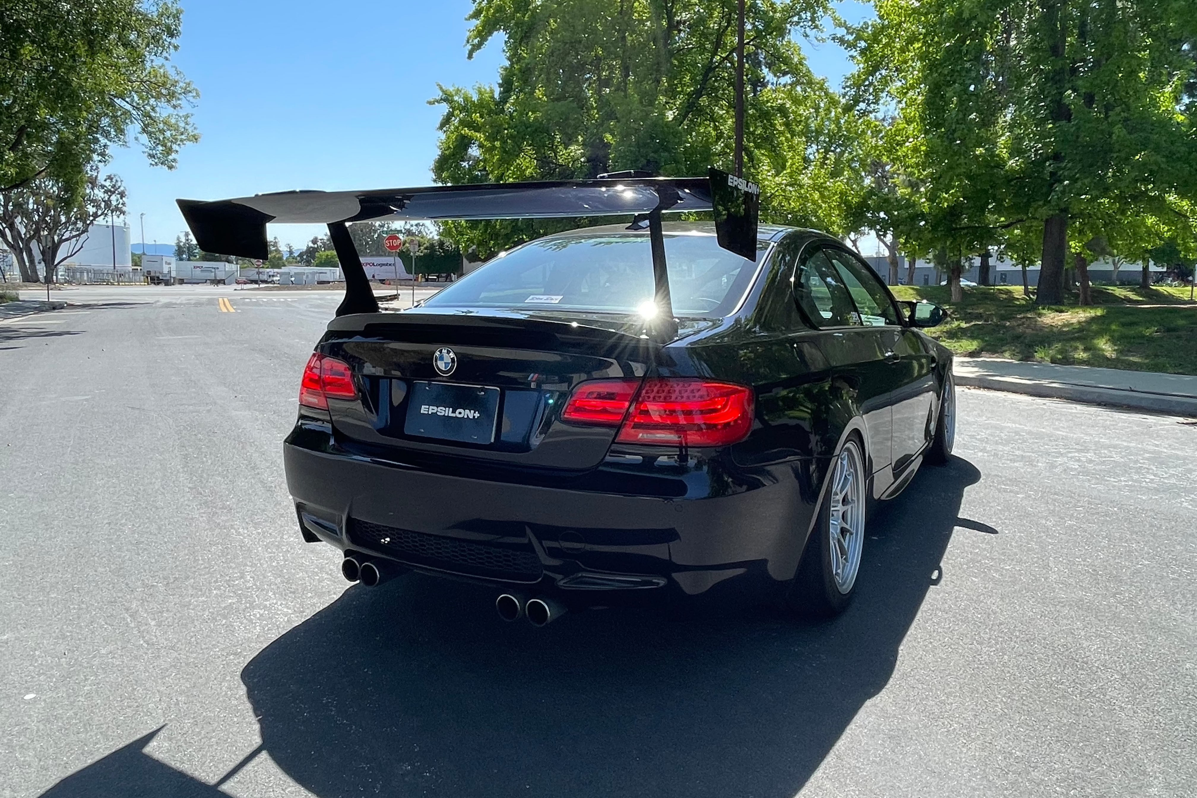 Low rear three-quarter view of a black BMW E92 M3 with GT wing
