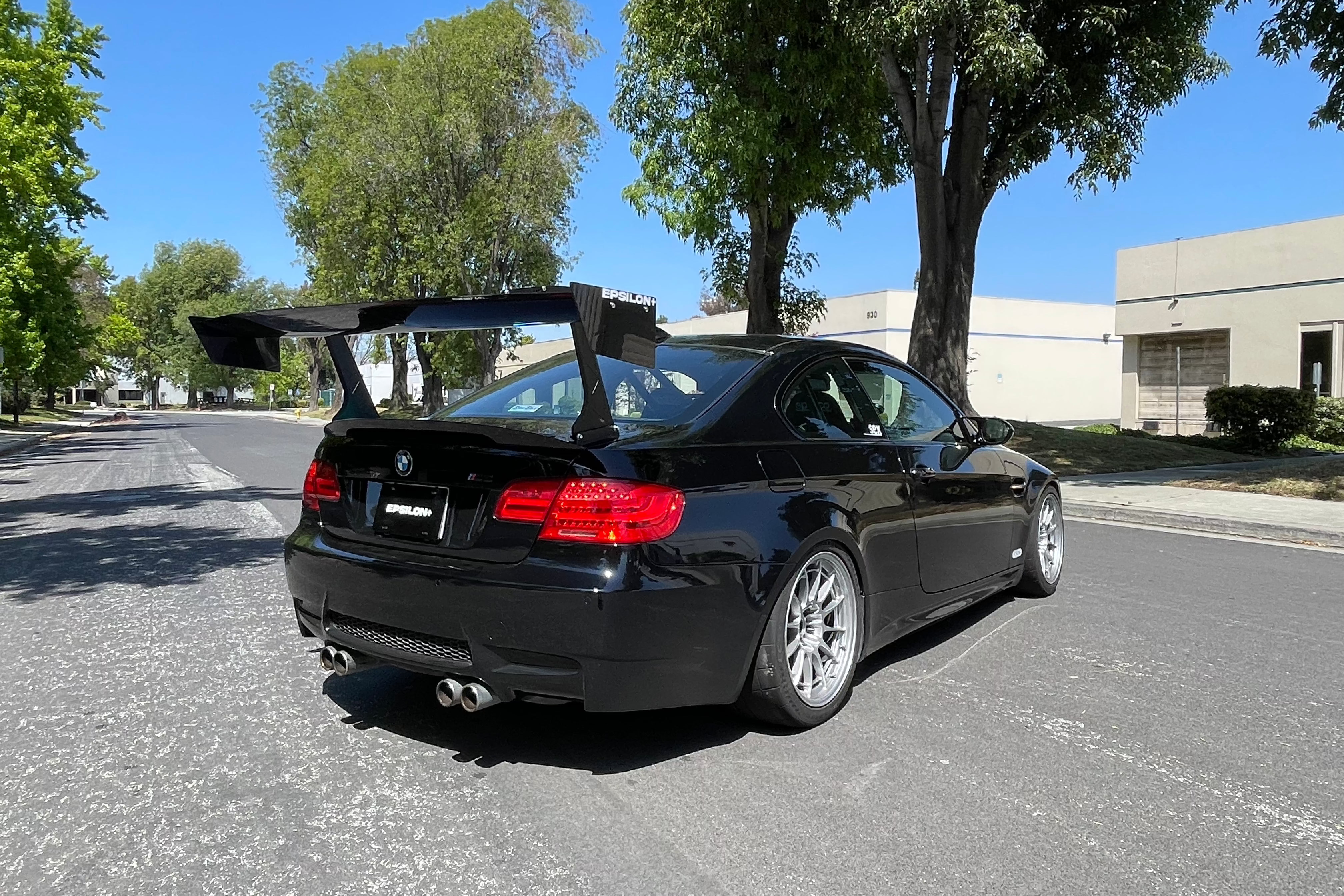 Rear view of a black BMW E92 M3 showing the full width of the GT wing